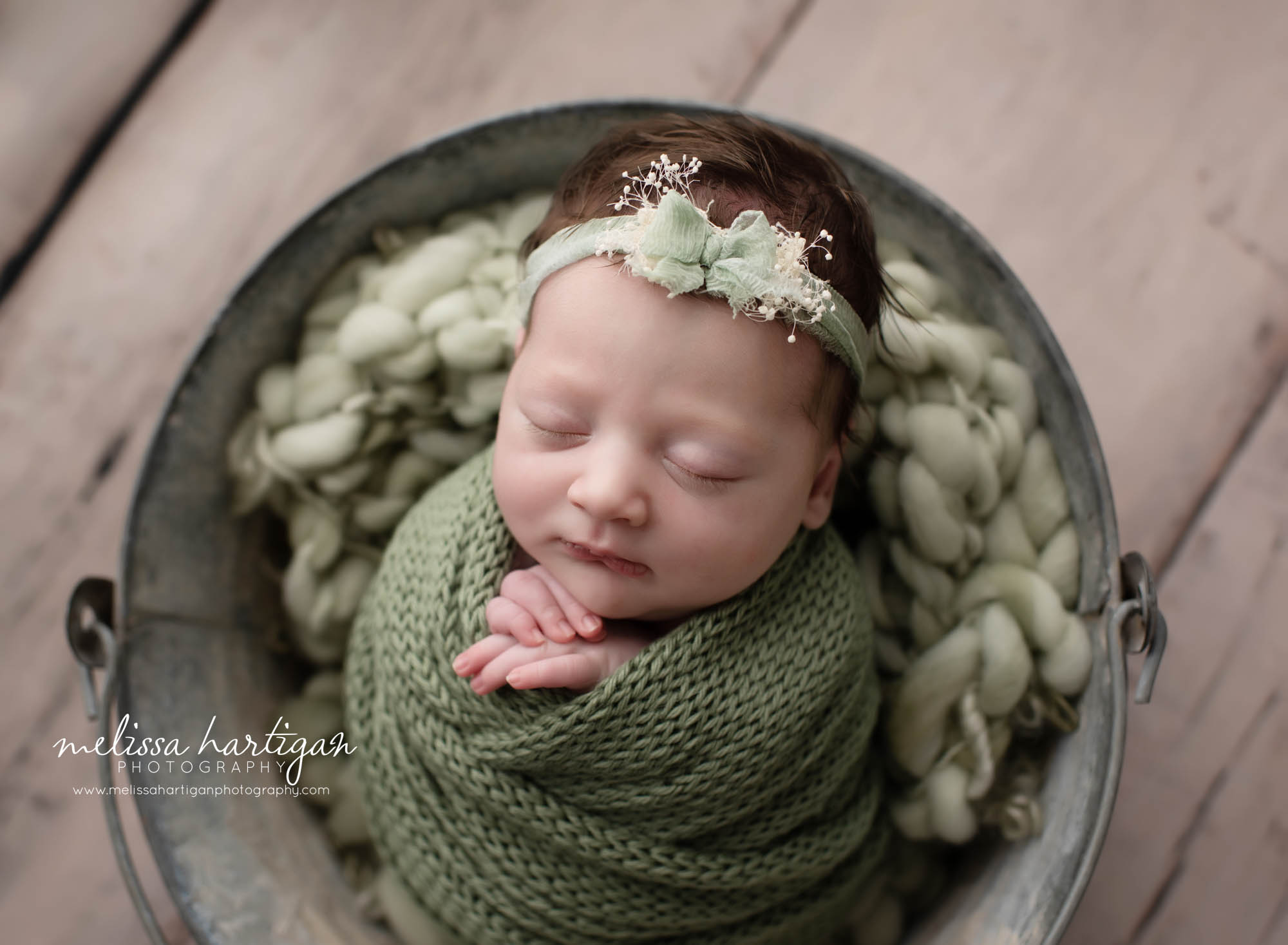 Newborn baby girl wrapped in green wrap with light green bow headband CT Newborn Photography