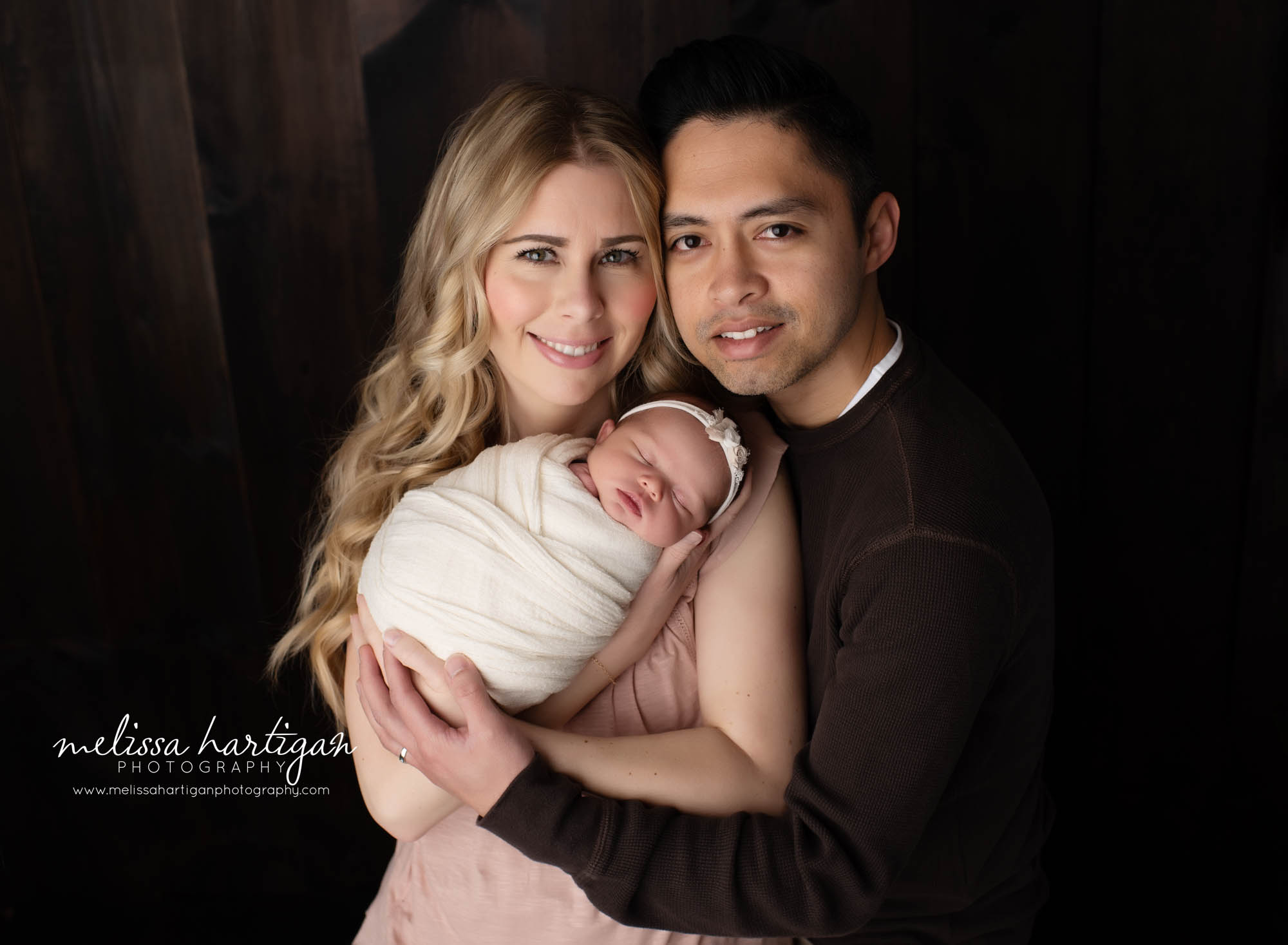 mom dad and newborn baby girl in newborn photo session family pose