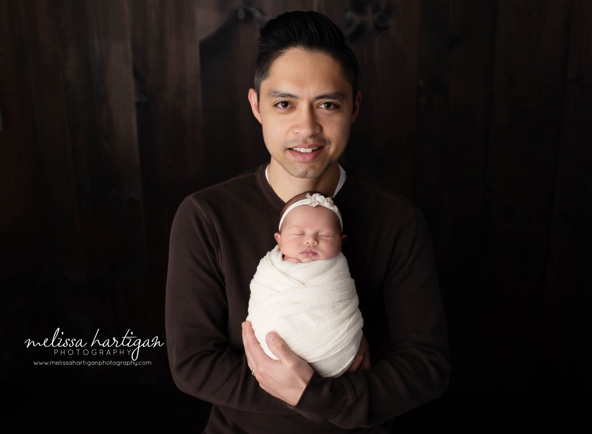 dad holding newborn baby girl newborn photography studio session