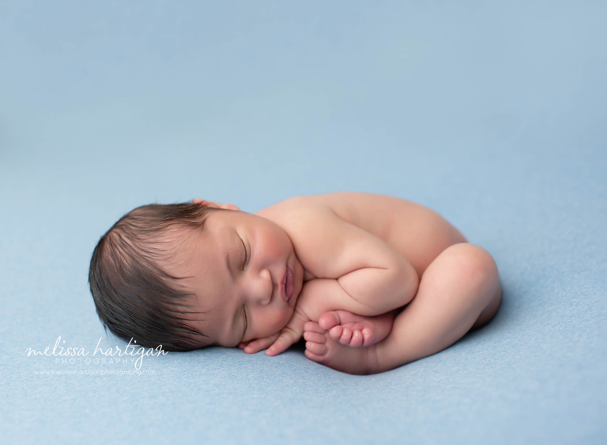 baby boy posed in taco pose newborn photography