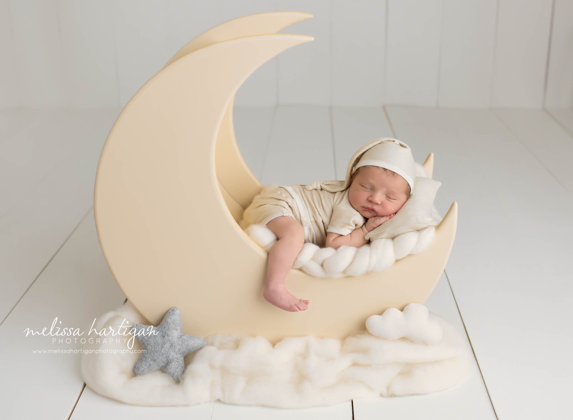 newborn baby boy posed on moon prop