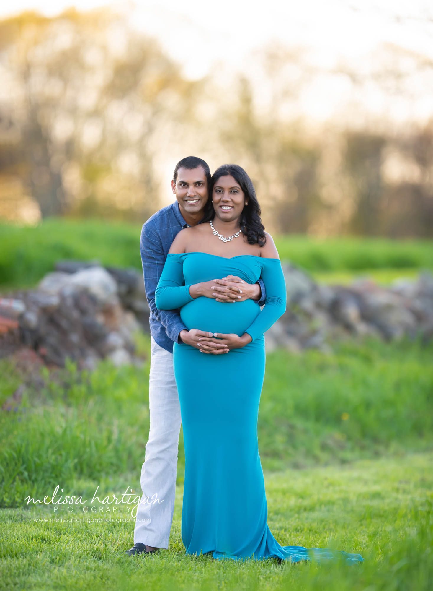 pregnant mom and dad holding baby bump standing maternity pose CT maternity photographer