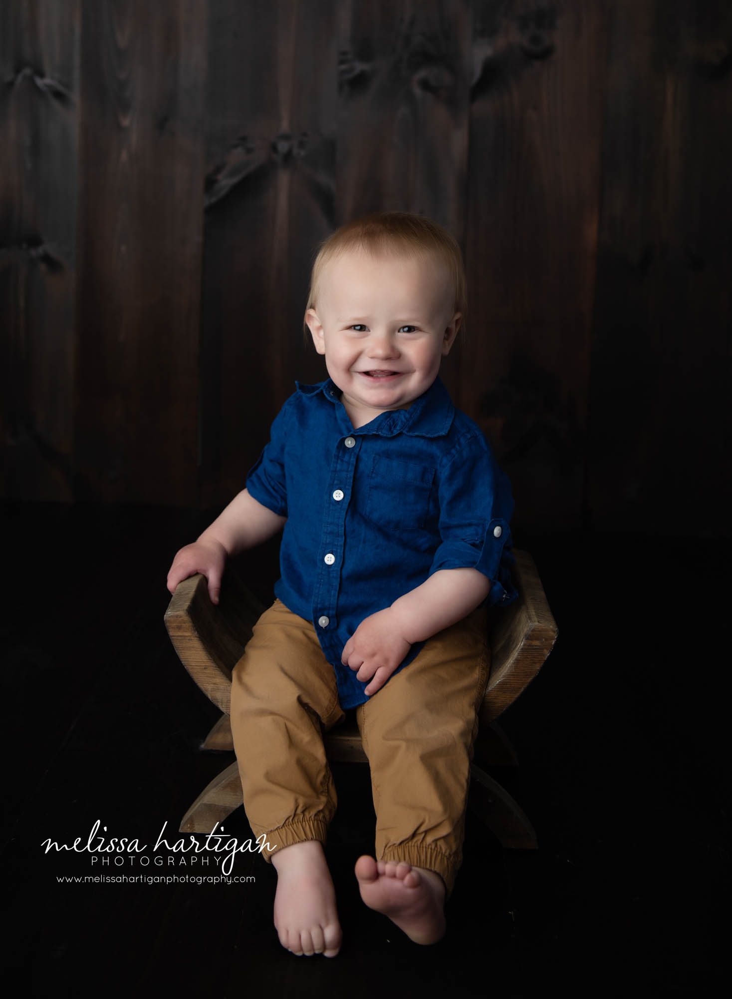 baby boy sitting on wooden curved bench milestone photos