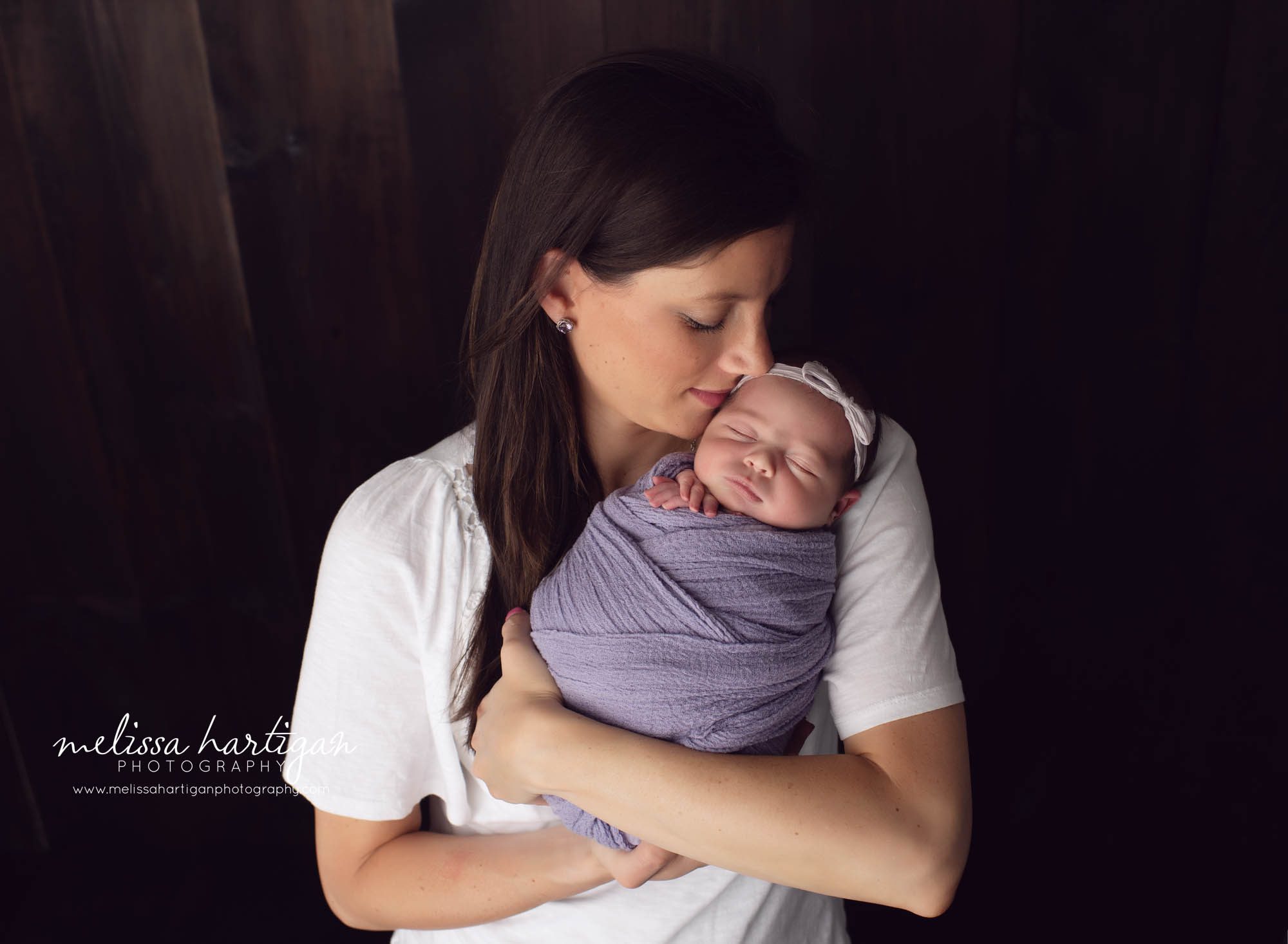 mom holding newborn daughter studio newborn session CT newborn photography