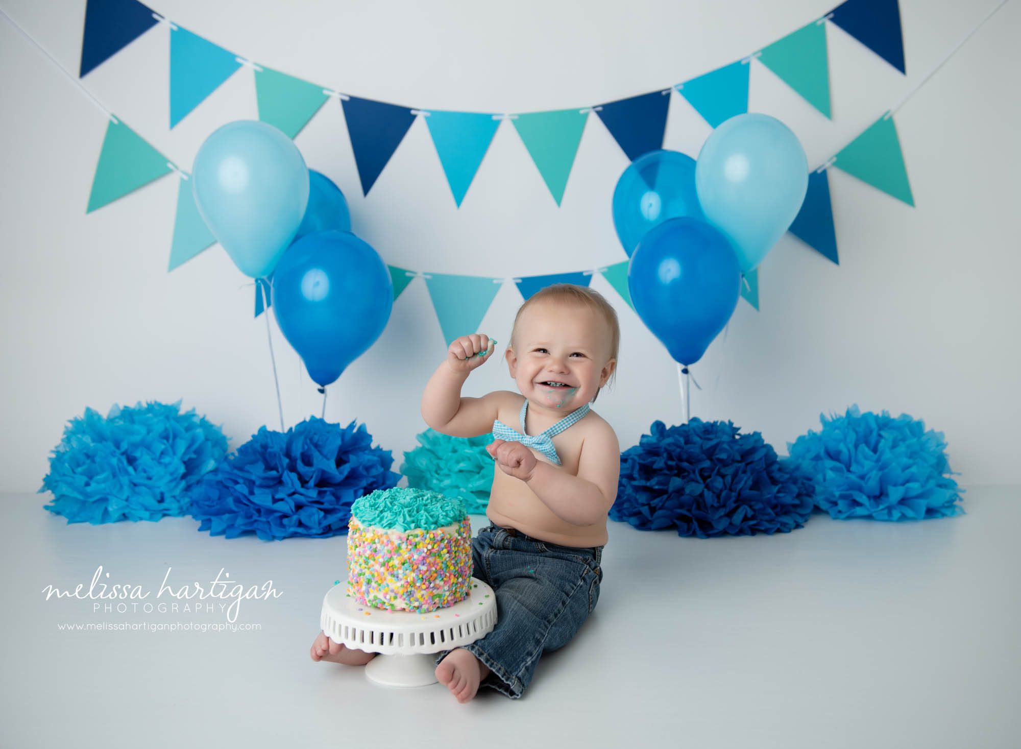 cake smash photo session with baby boy celebrating one year milestone