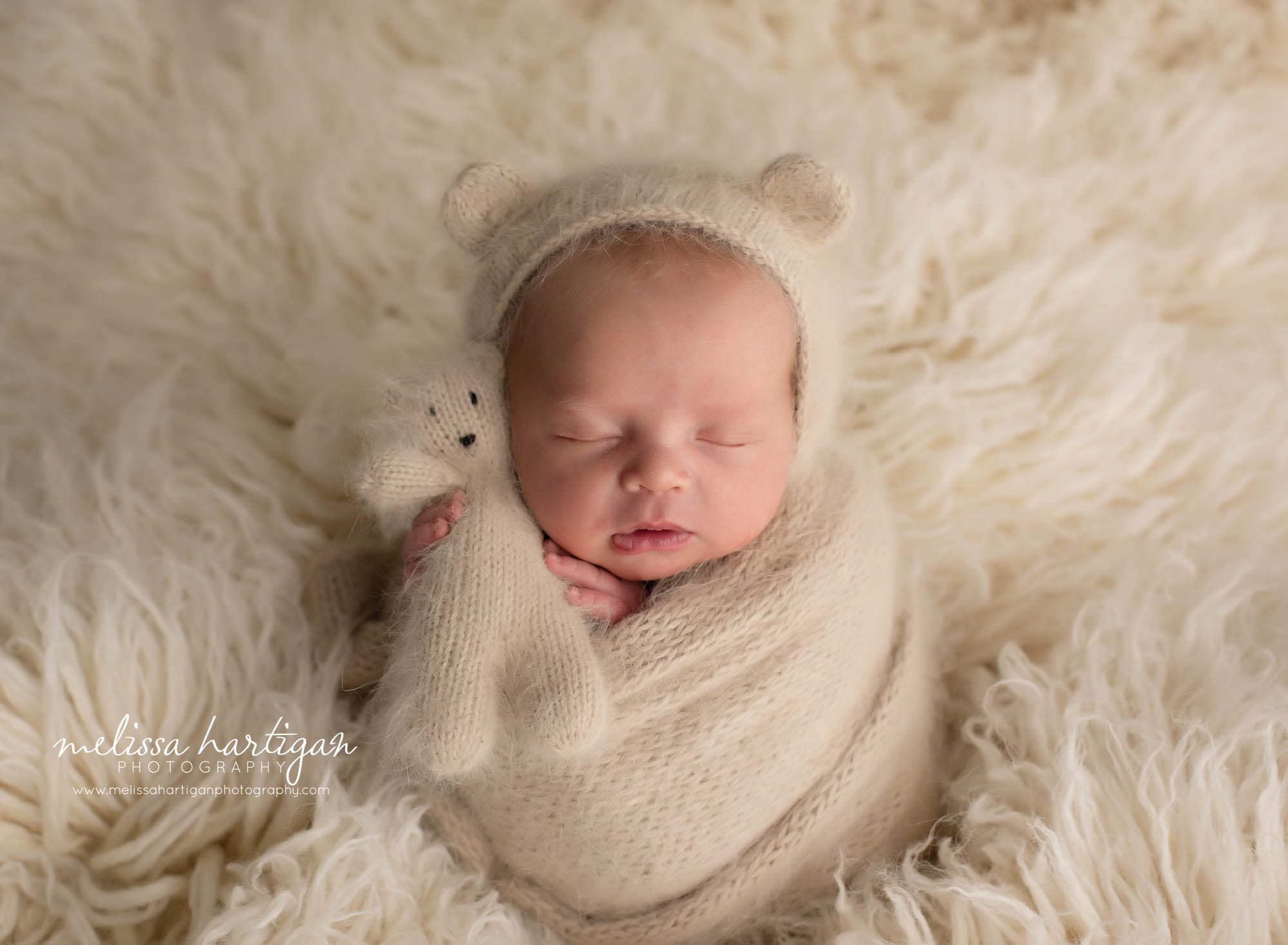 Baby boy wrapped in knitted wrap with matching bear bonnet and teddy bear newborn photography CT