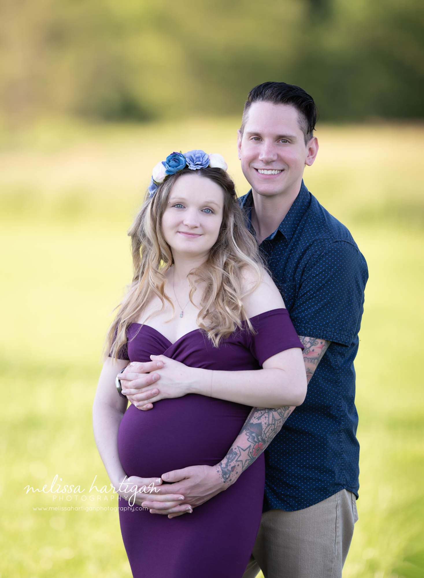 expectant couple handling holding baby bump