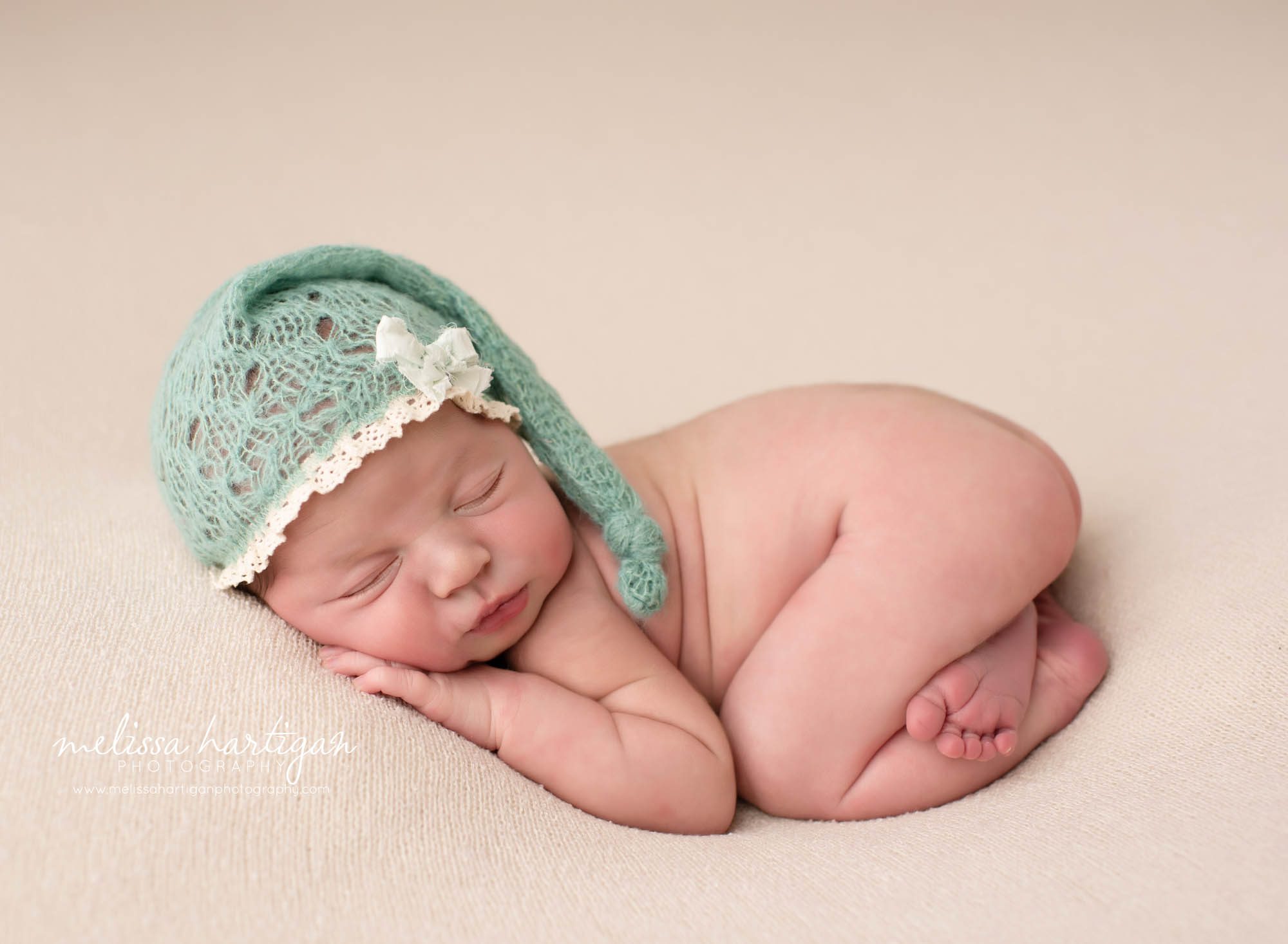 baby girl posed bum up pose with teal knitted sleepy cap Ct newborn photographer