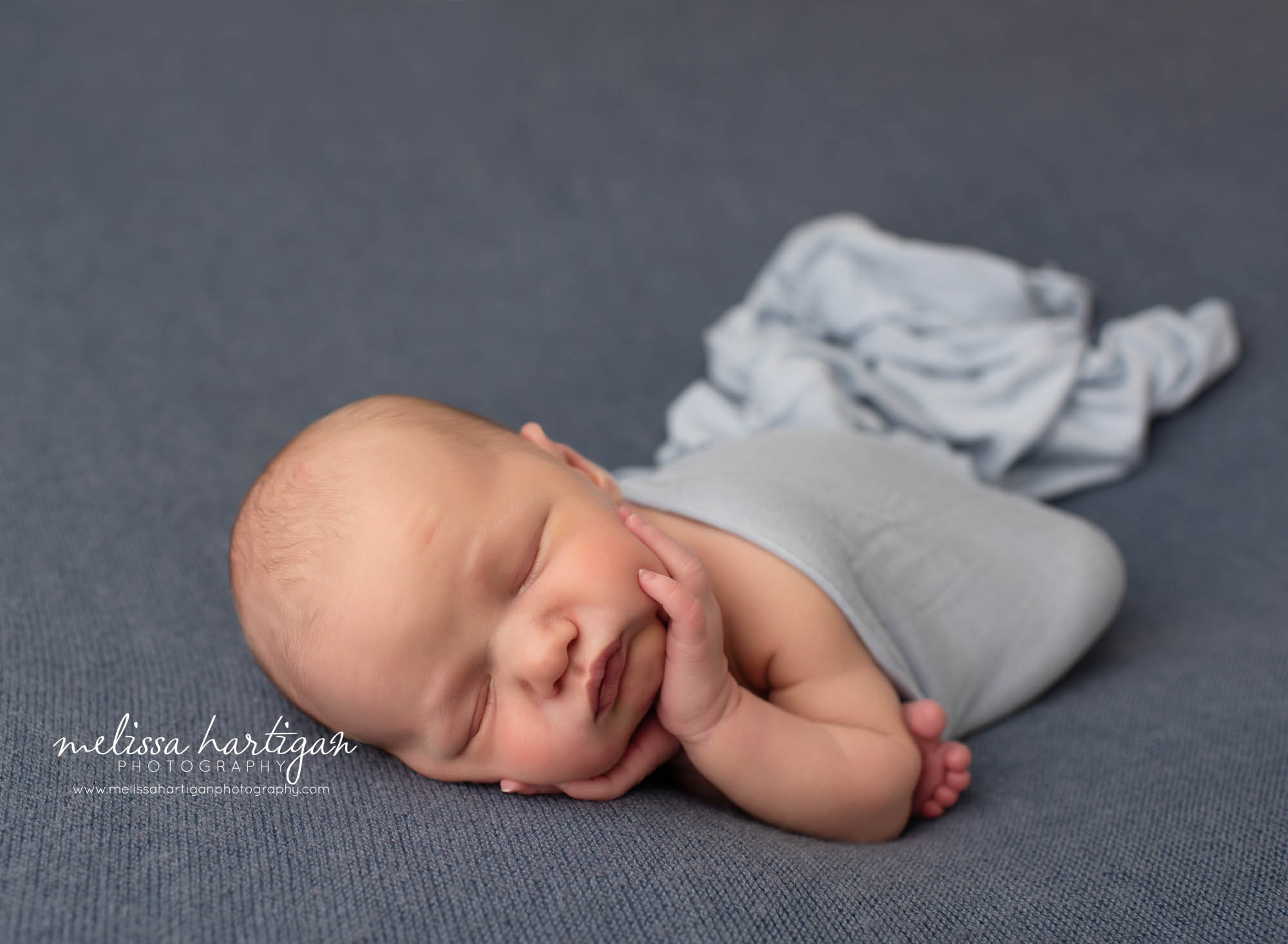 baby boy posed on side timber pose newborn photography studio photographer tolland connecticut newborn photography