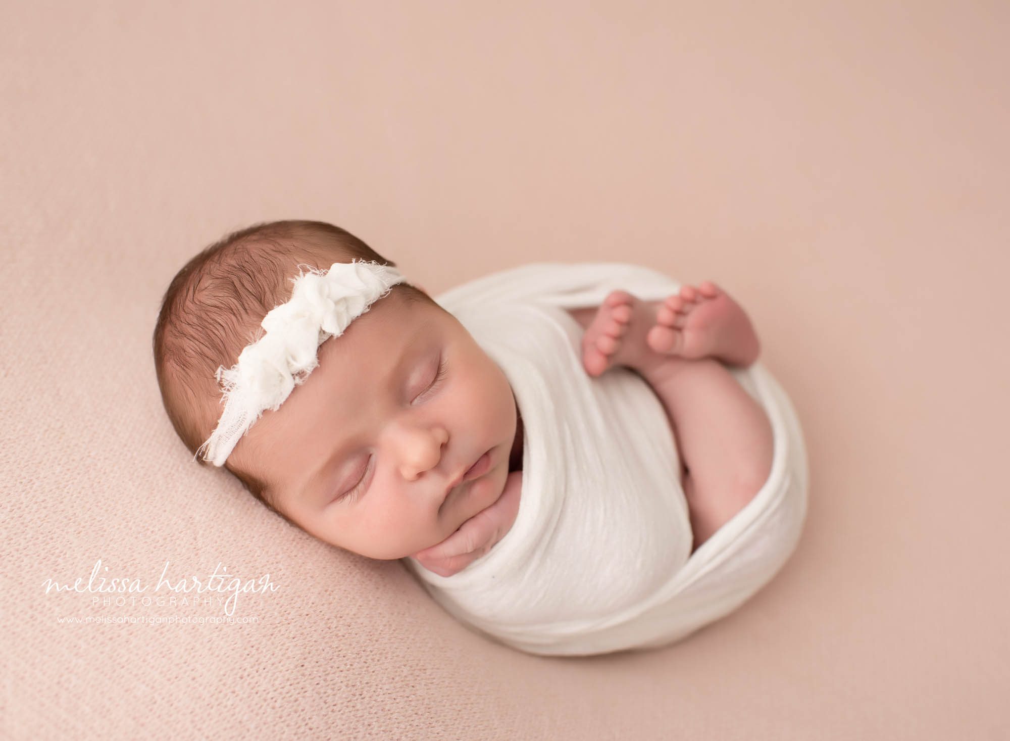 baby girl wrapped in white wrap with white headband Suffield CT Newborn Photographer