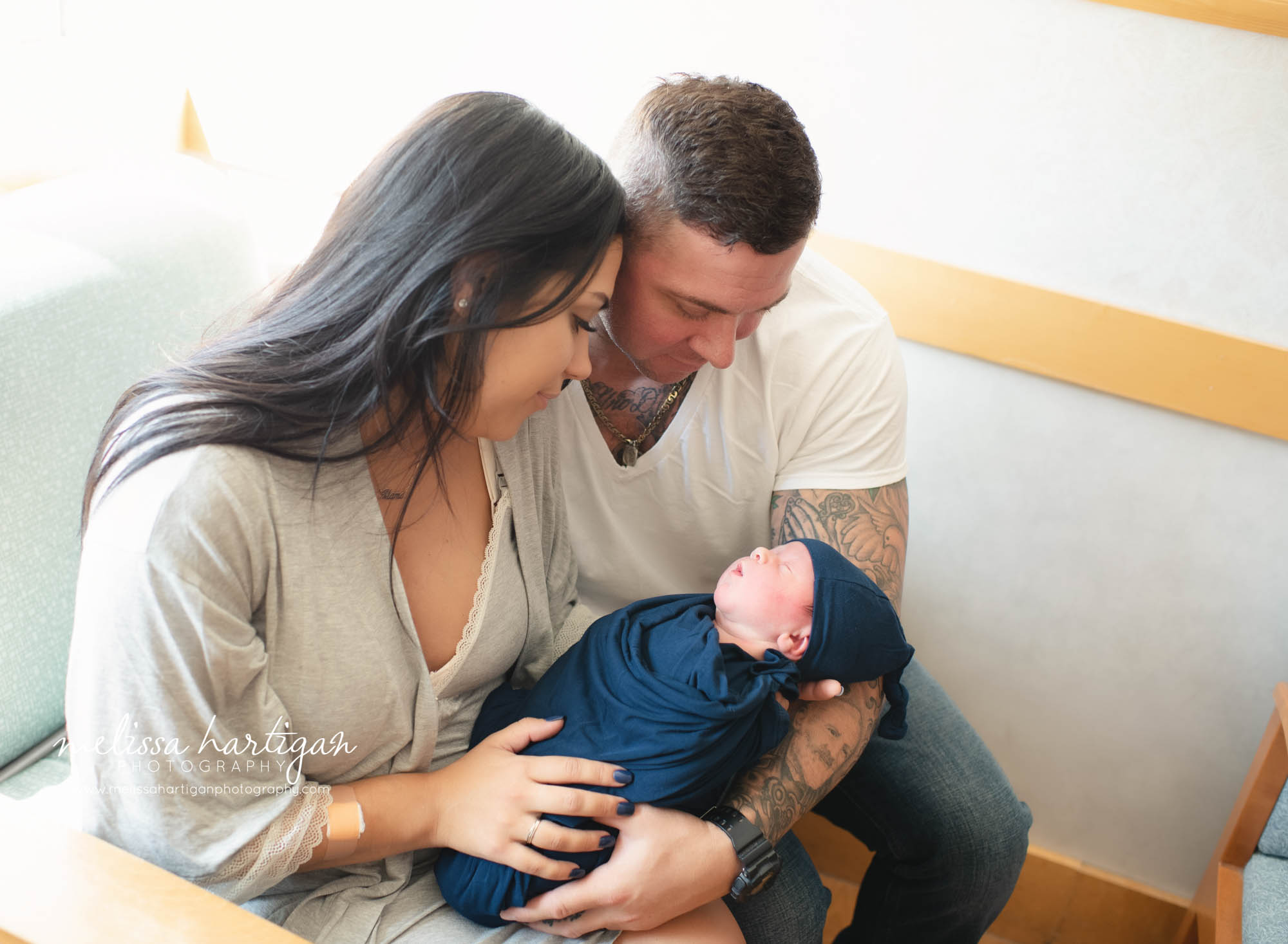 parents holding their newborn son in hospital room manchester ct baby photographer