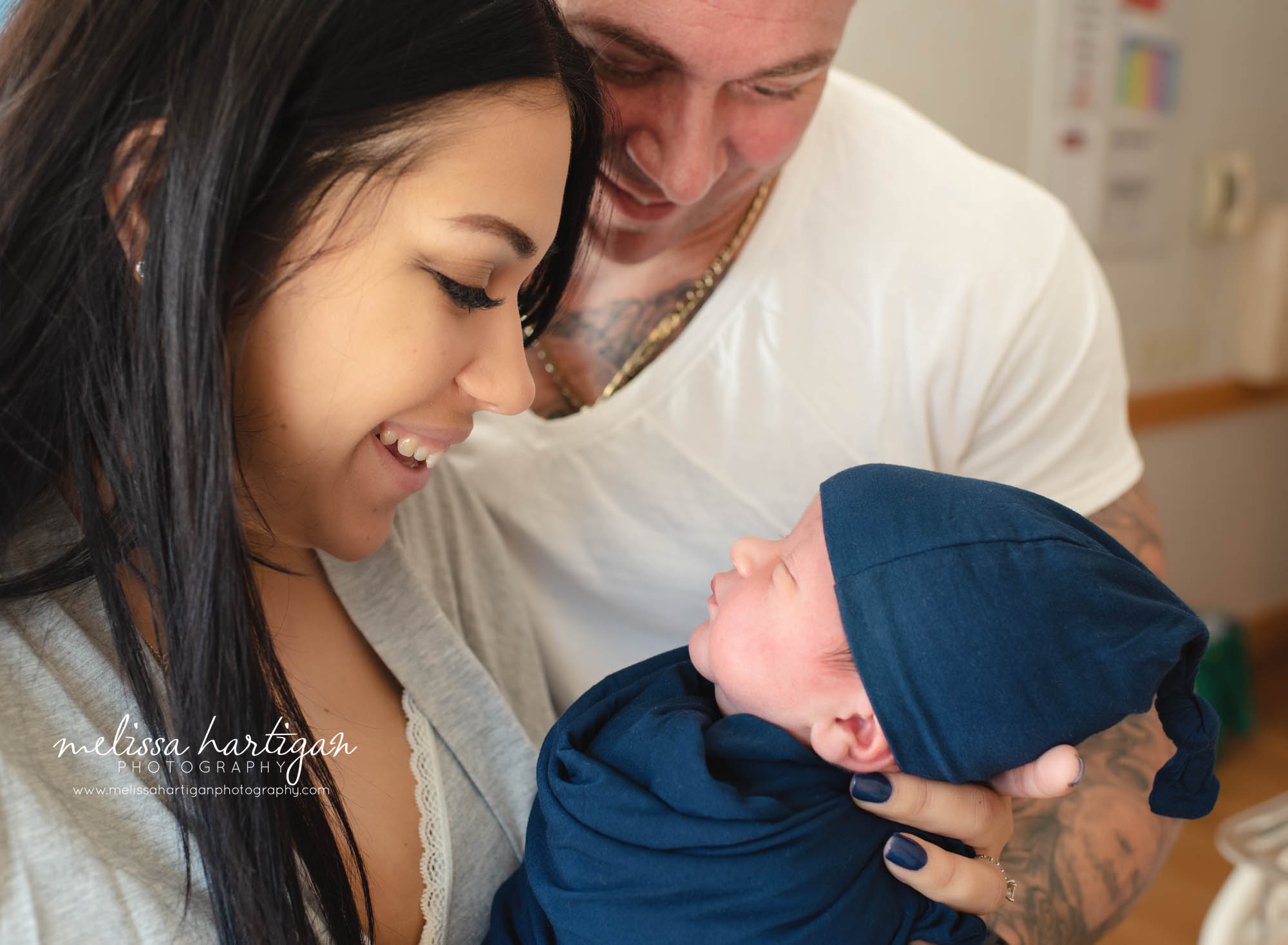parents holding their newborn son in hospital room manchester ct baby photography