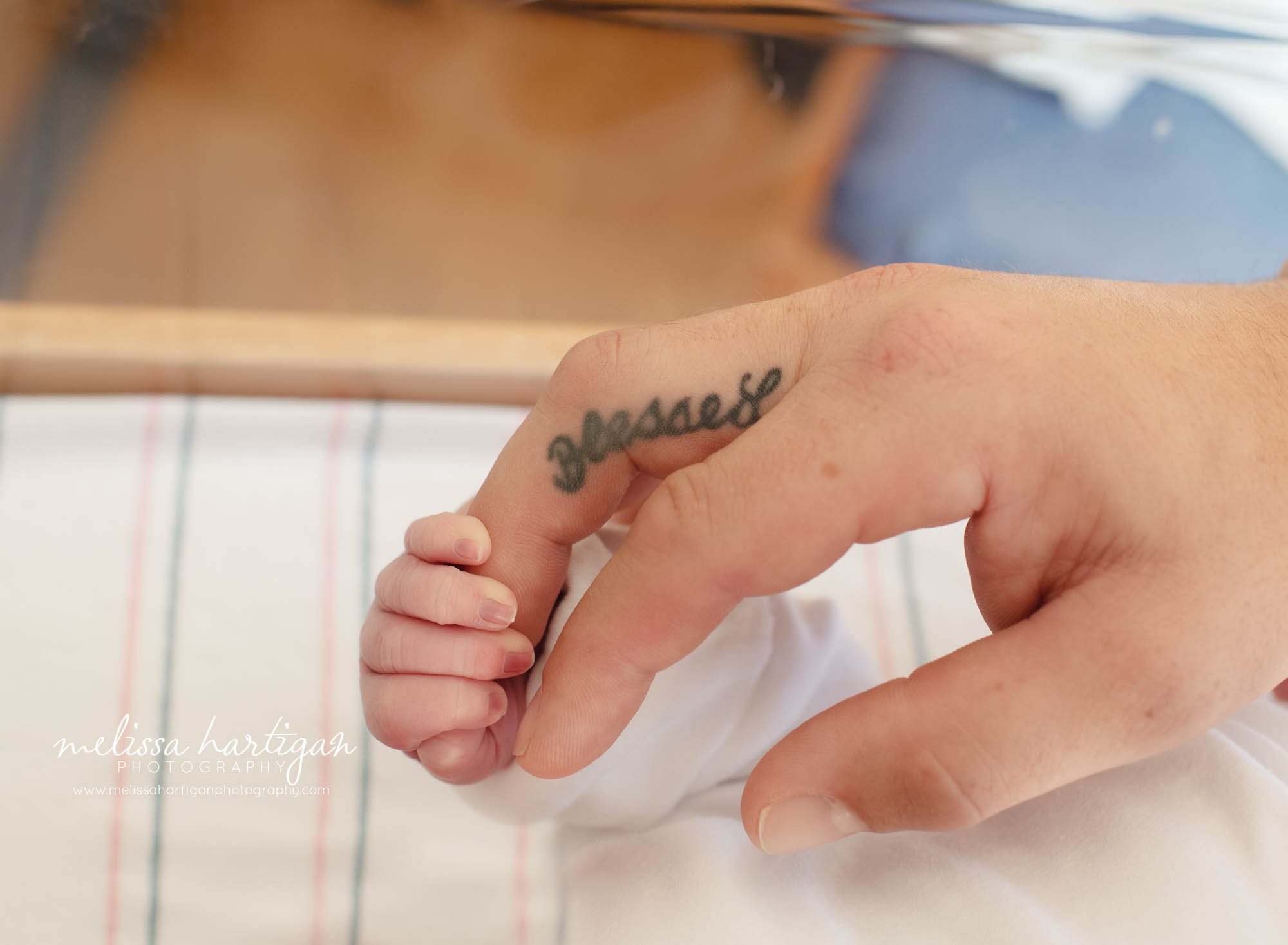 Newborn baby holding dads finger