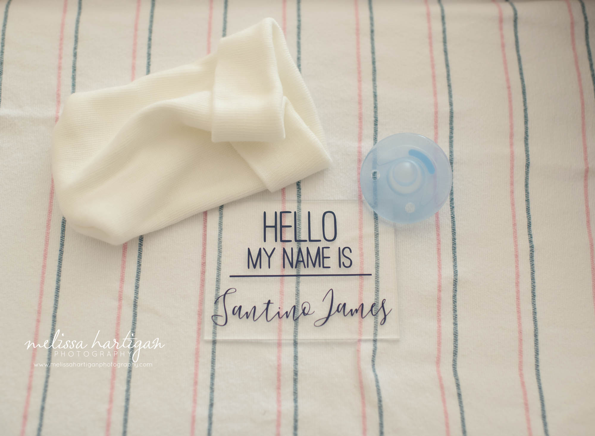 newborn toque and pacifier with hello my name is sign