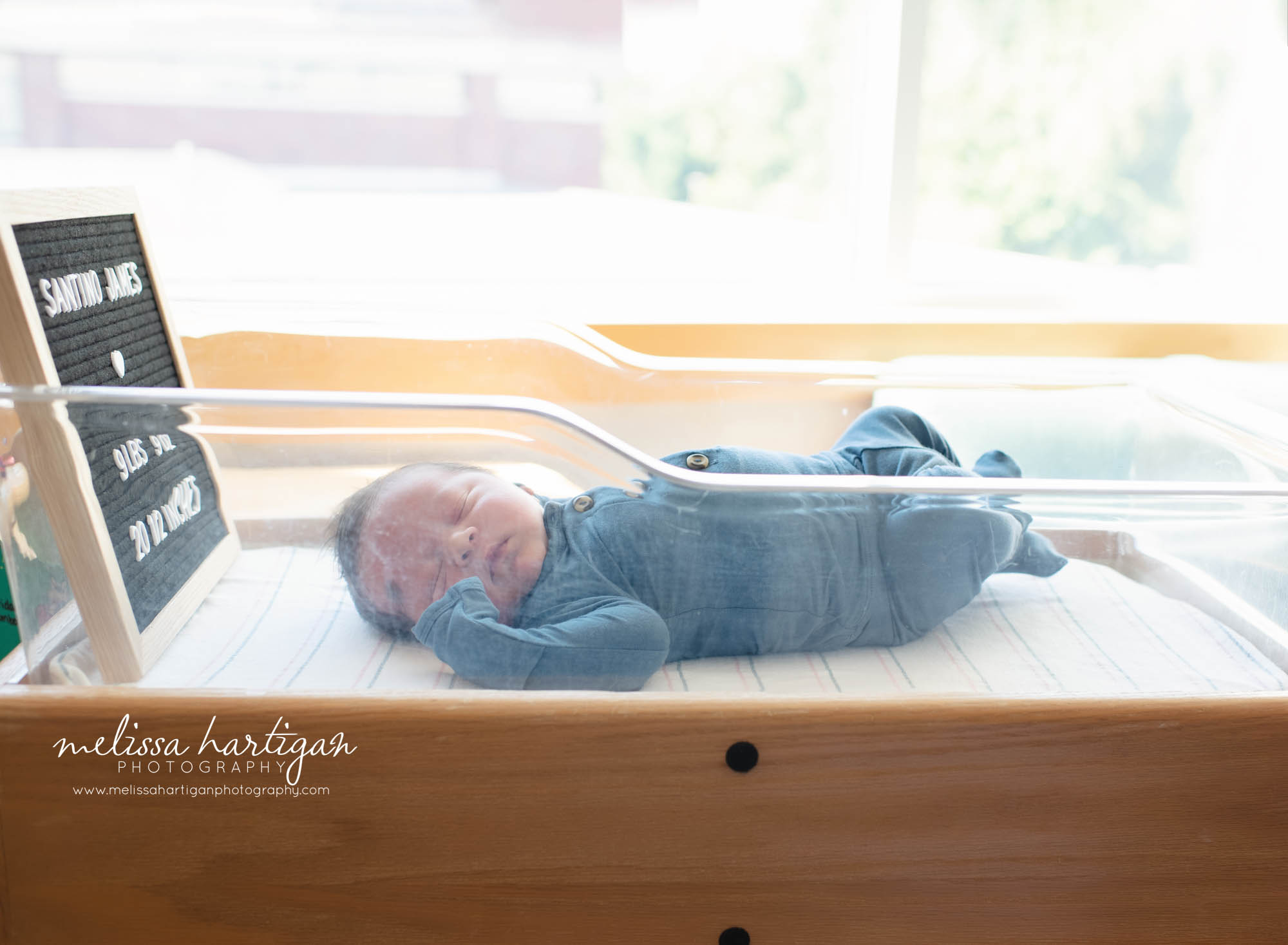 baby boy laying in hospital bassinet