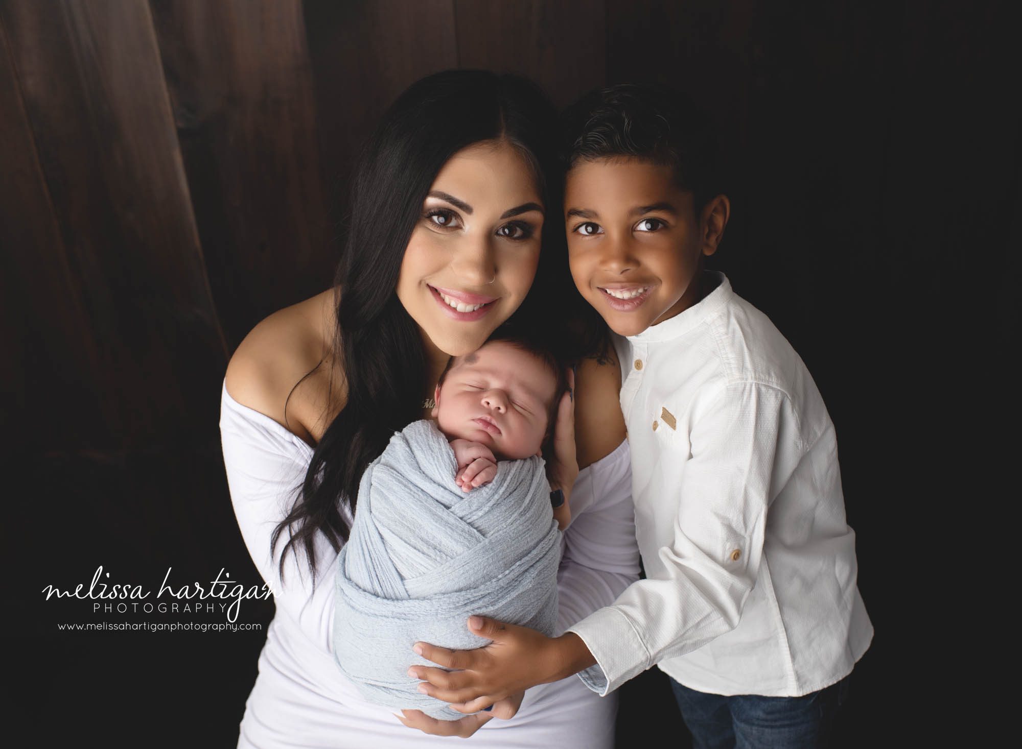 mom and her two boys studio newborn photo session