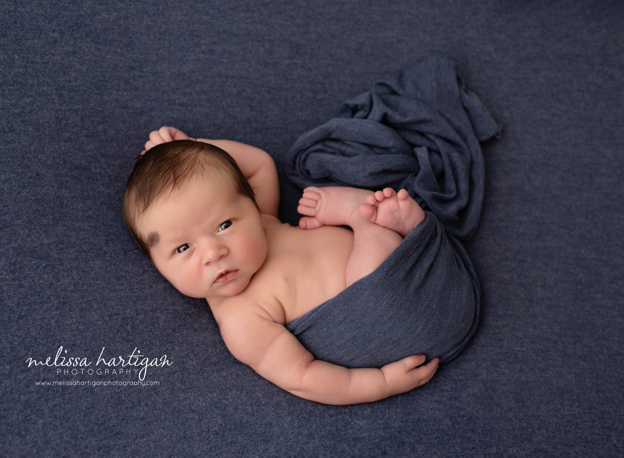 baby boy eyes open looking at camera posed newborn photography