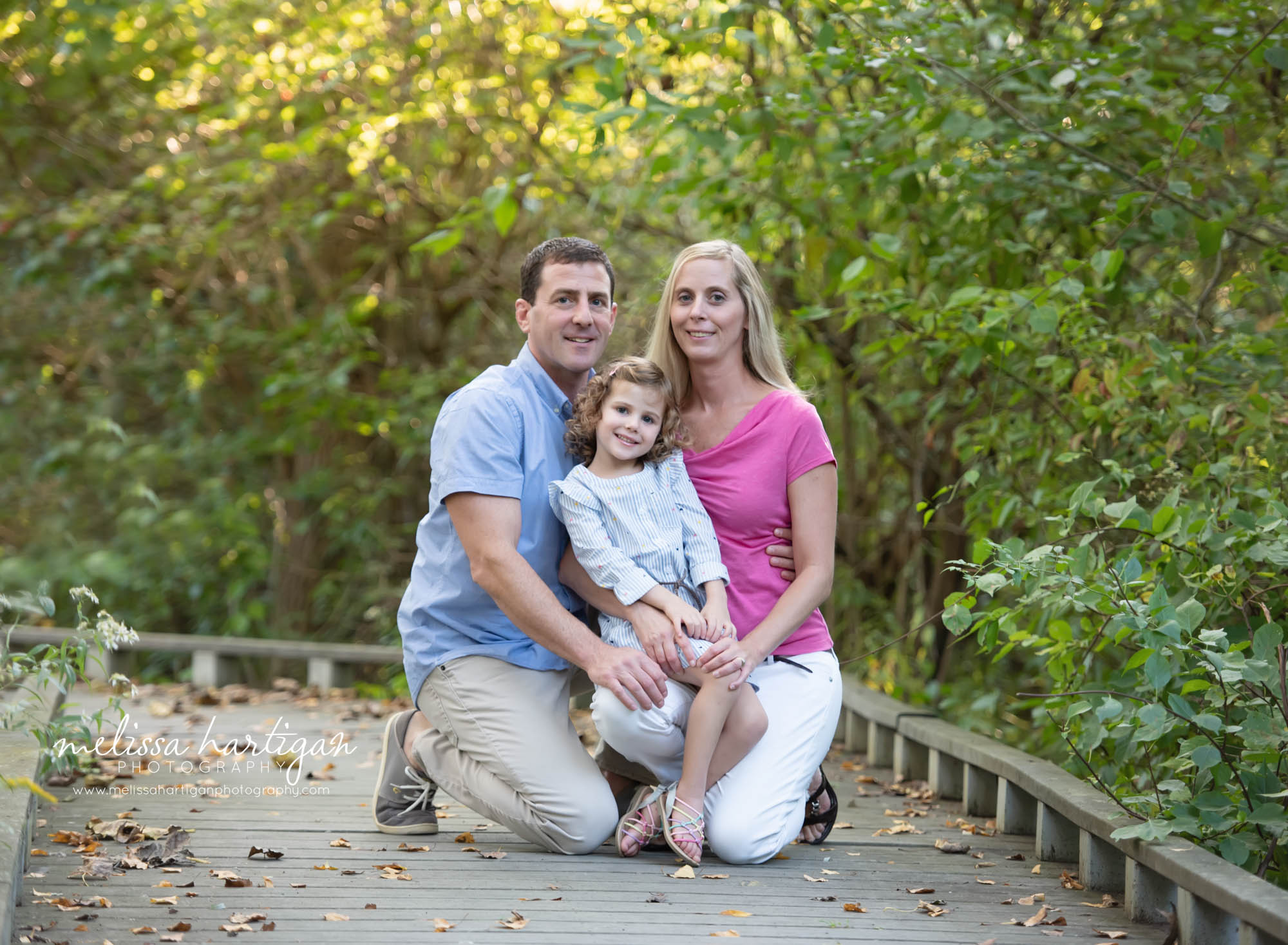 mom dad and daughter kneeling family photo CT Photographer
