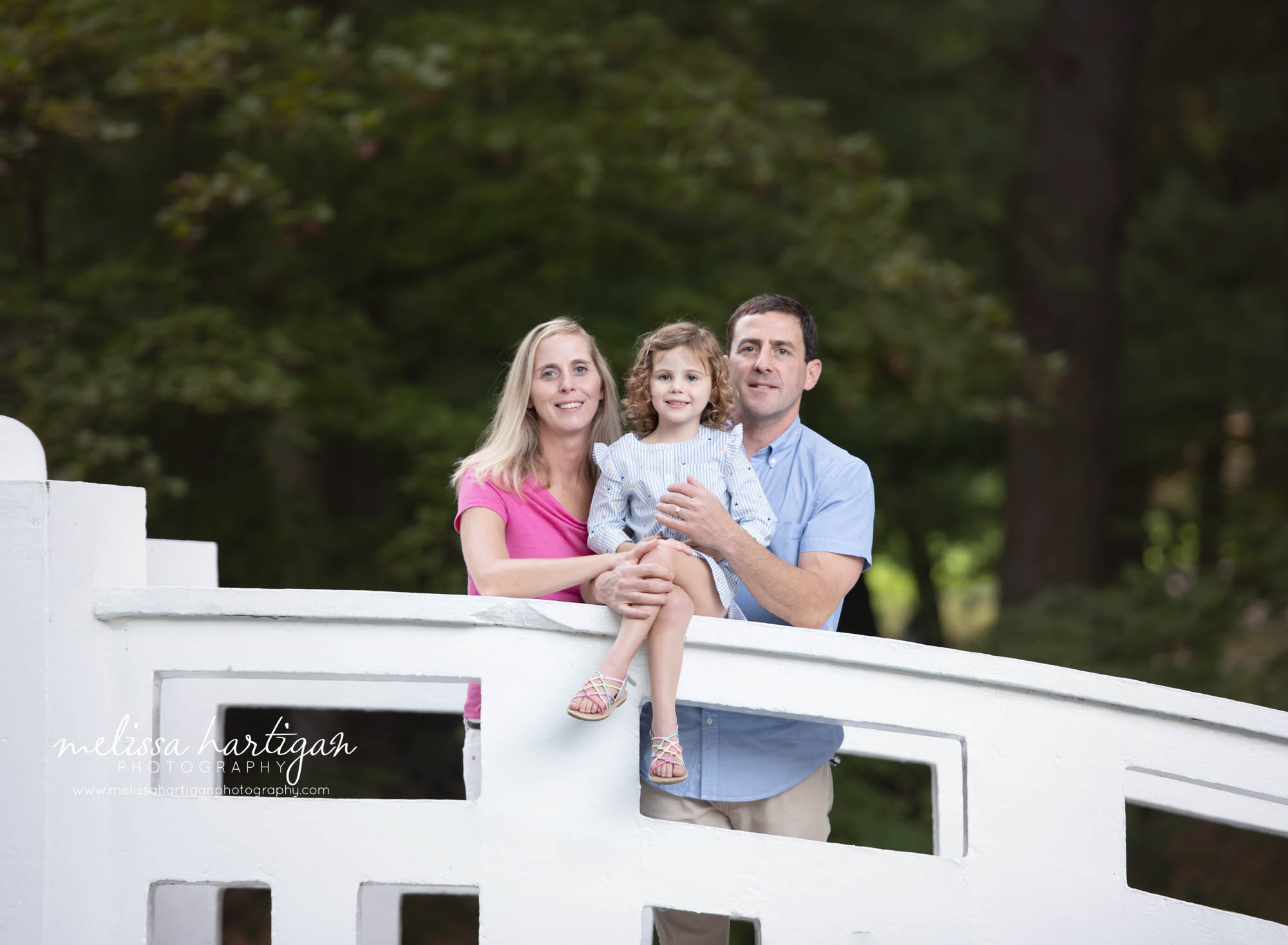 mom dad and daughter family photo on bridge in Wickham Park CT Photographer