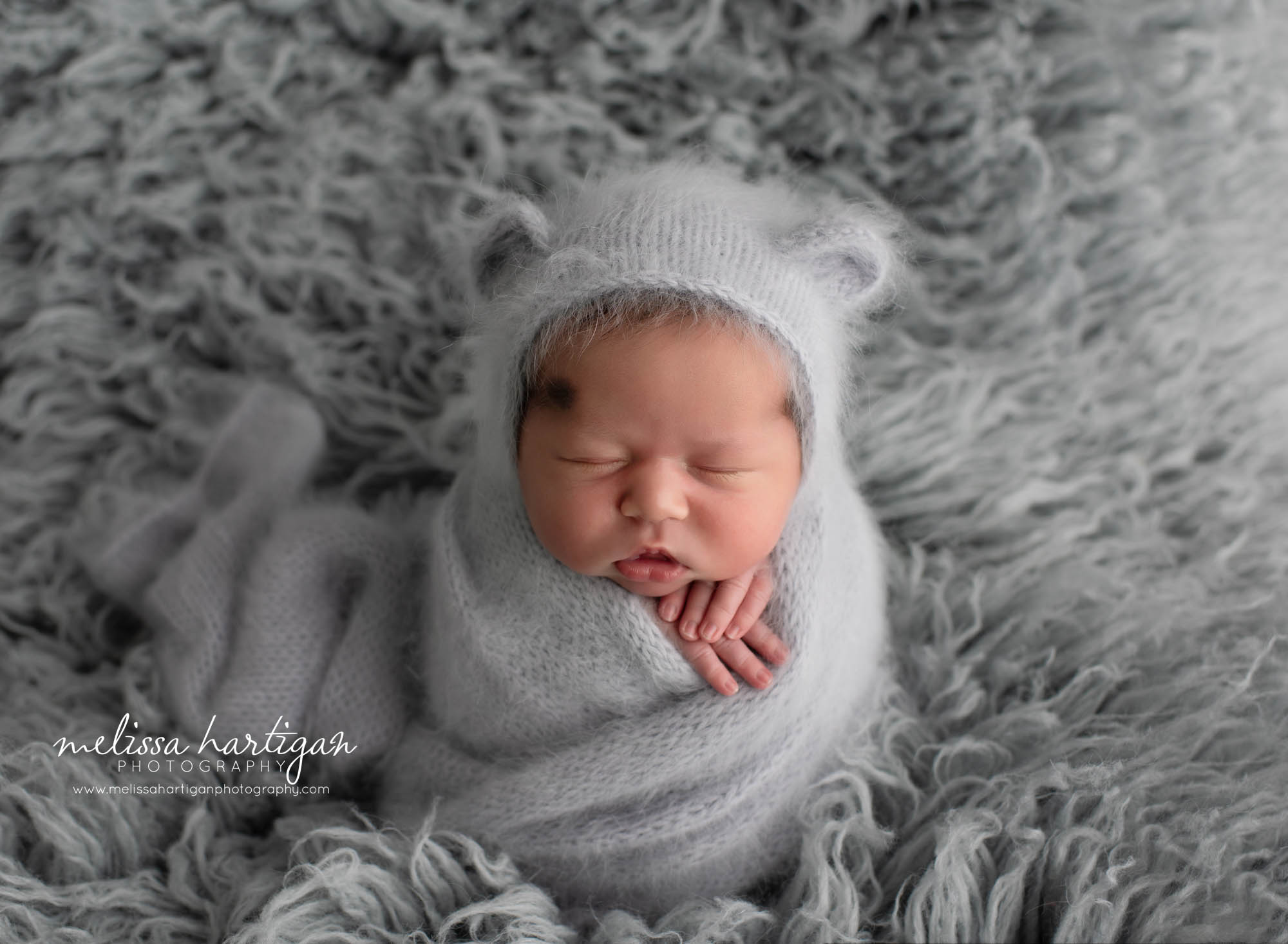 baby boy wrapped in light gray knitted wrap and matching bear bonnet newborn baby photography CT