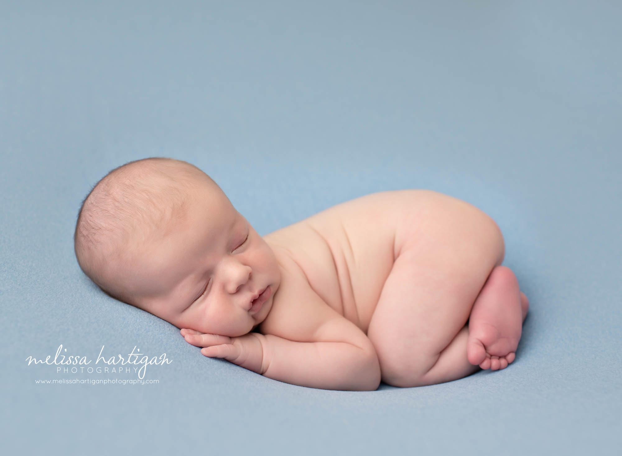 baby boy posed on light blue backdrop Enfield CT Newborn photographer