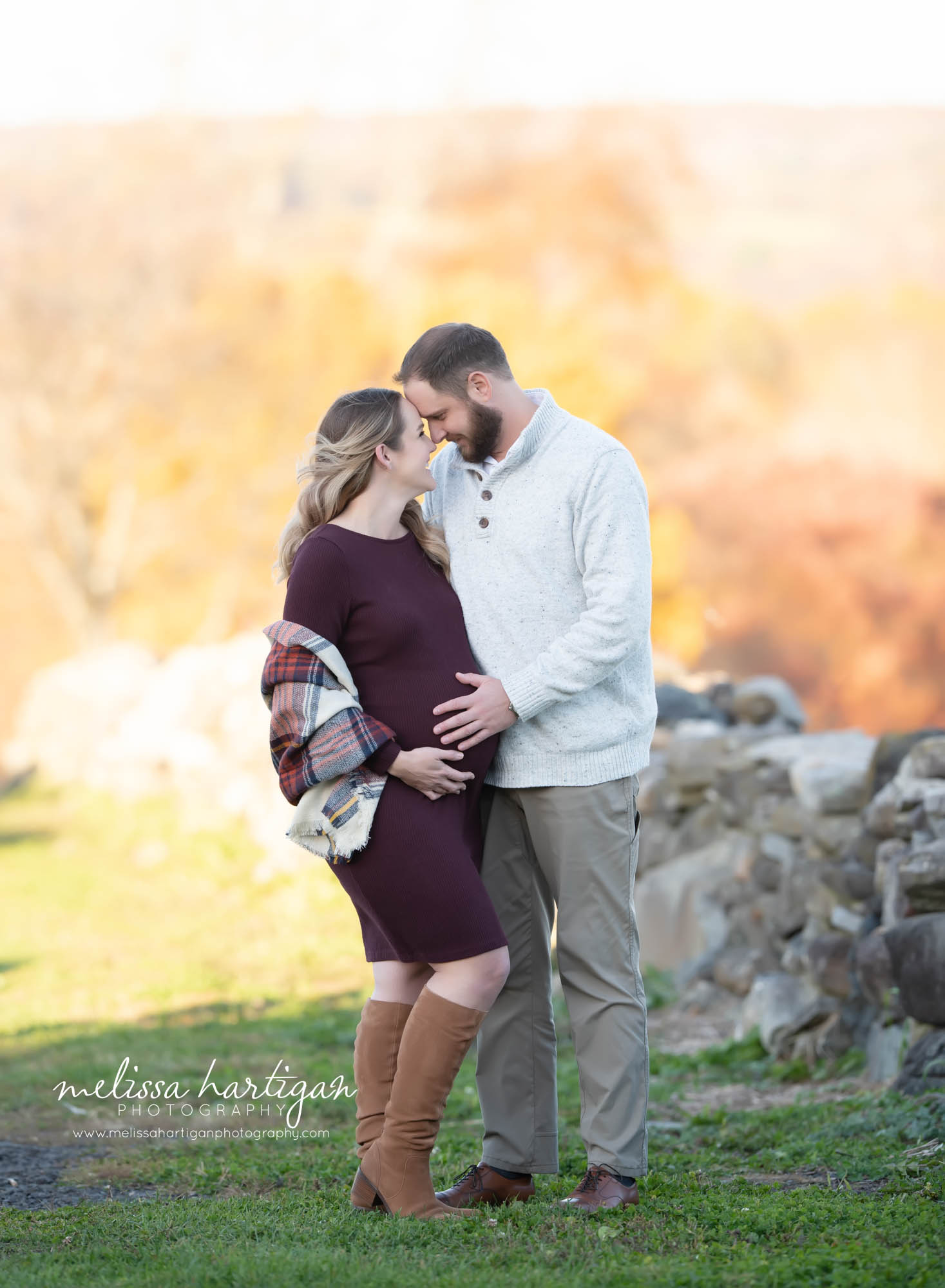 pregnant mom and expectant dad holding baby bump outside maternity pictures CT