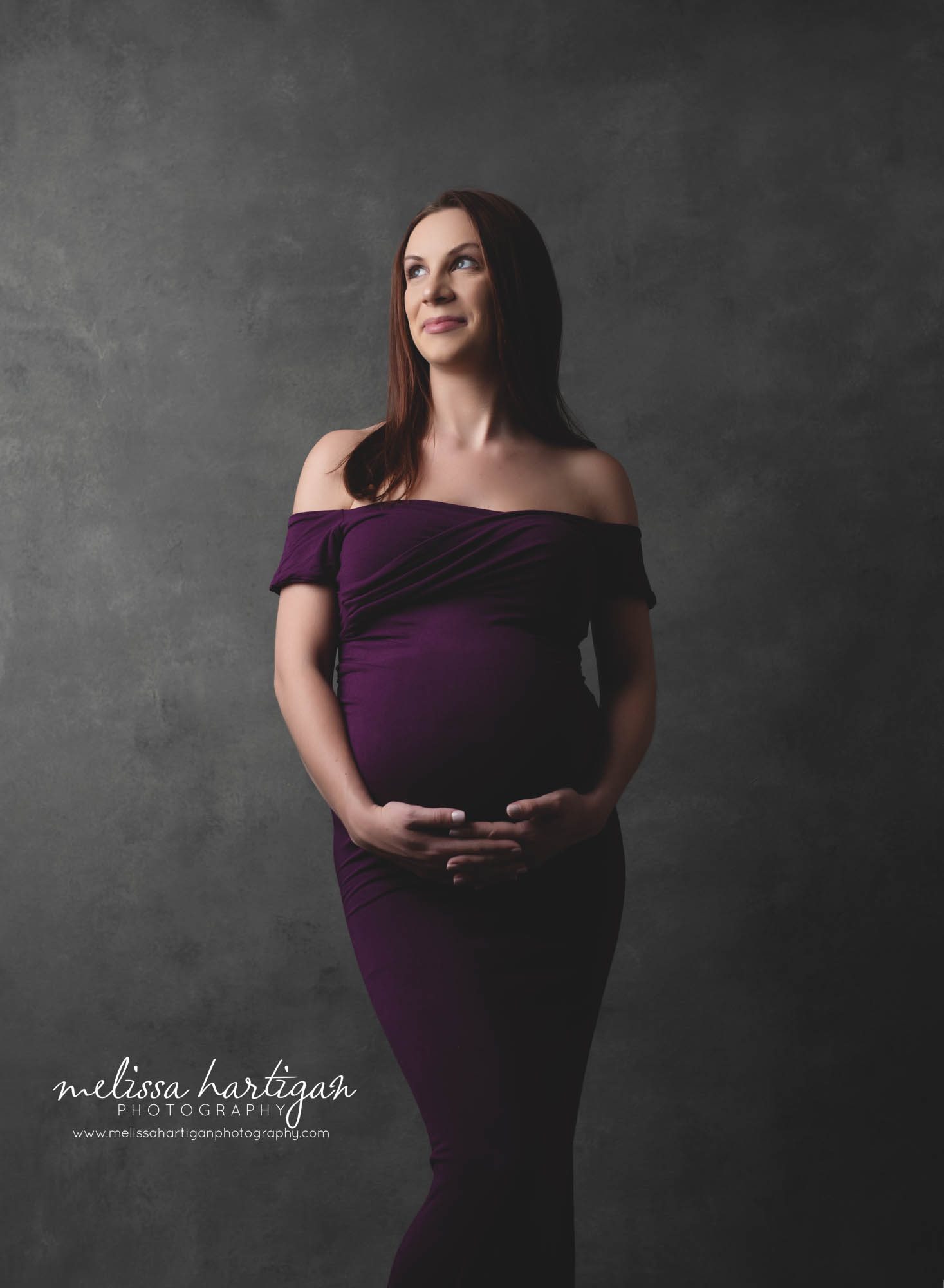 Pregnant mom wearing long purple dress studio maternity pictures CT maternity Photographer