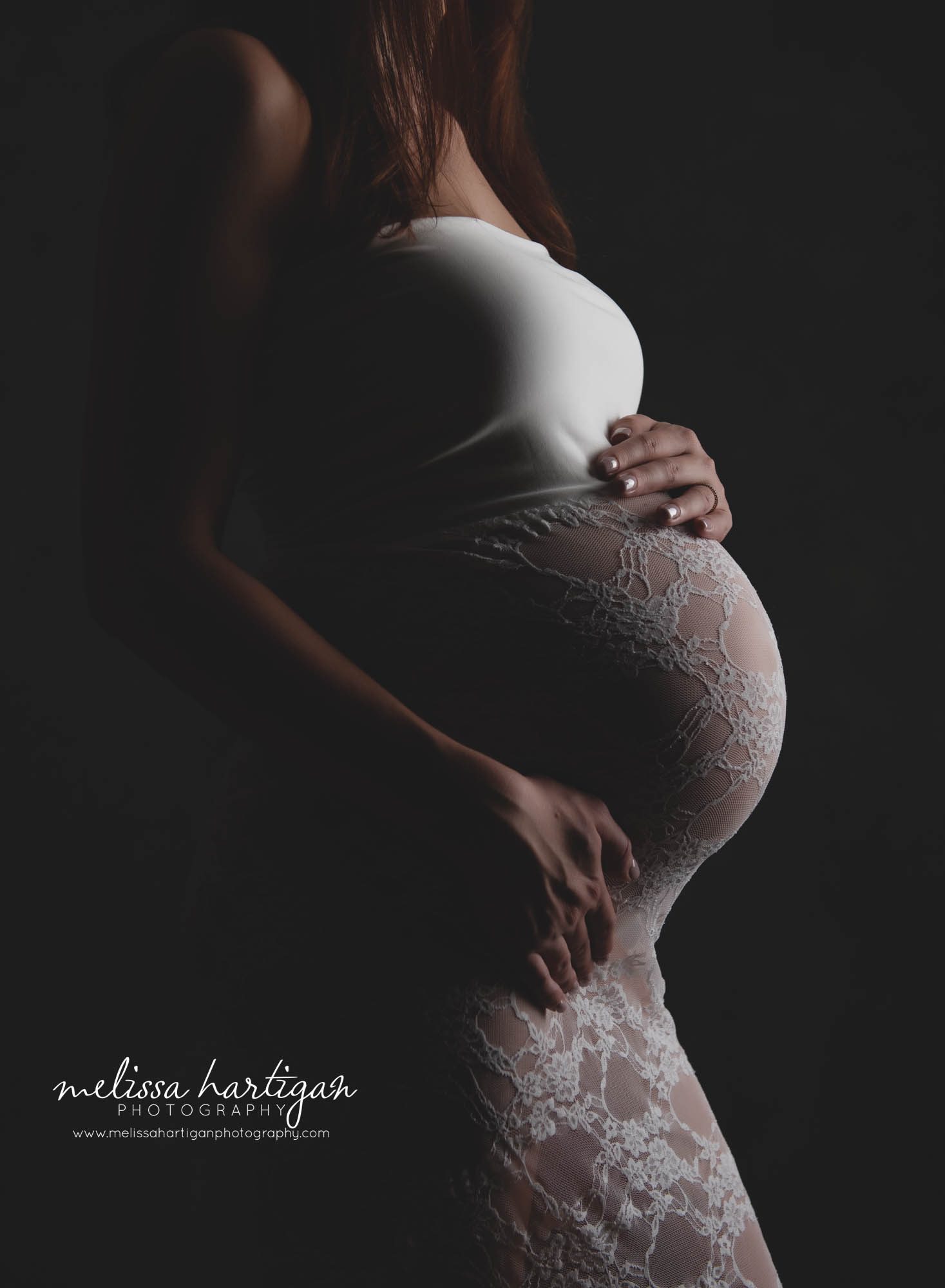 Pregnant mom belly in studio maternity session