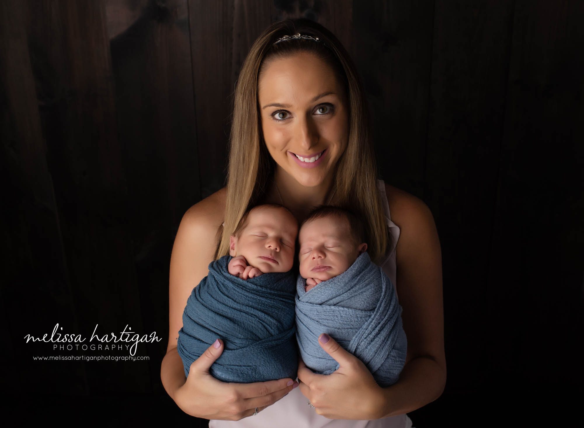 Mom holding wrapped twin boys studio newborn family photography CT