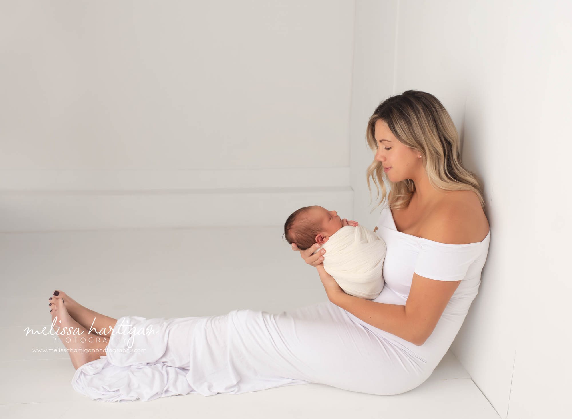 New mom holding her newborn son wrapped up in parent photo newborn photography pictures CT