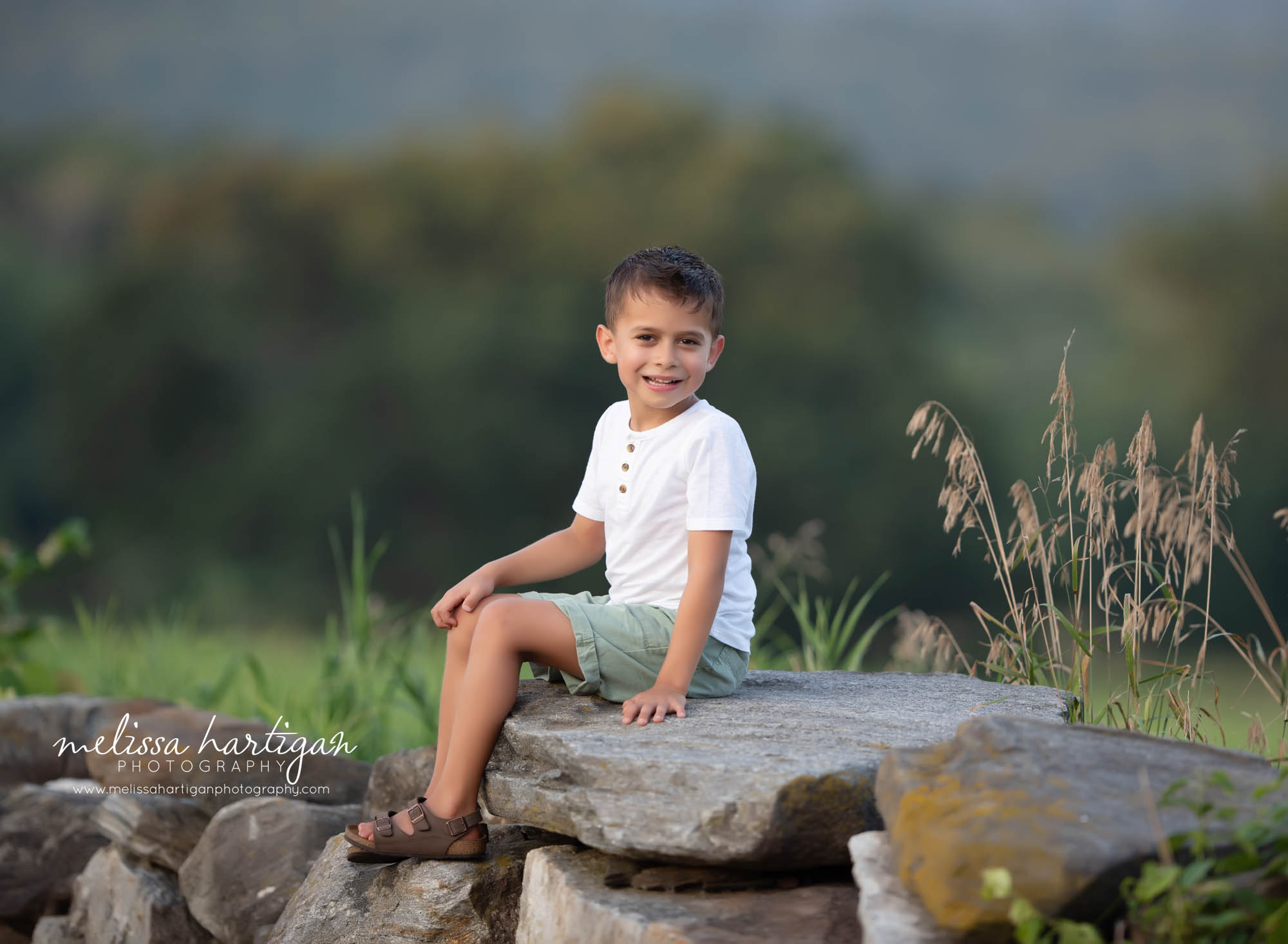 child sitting on rock CT family Photography session