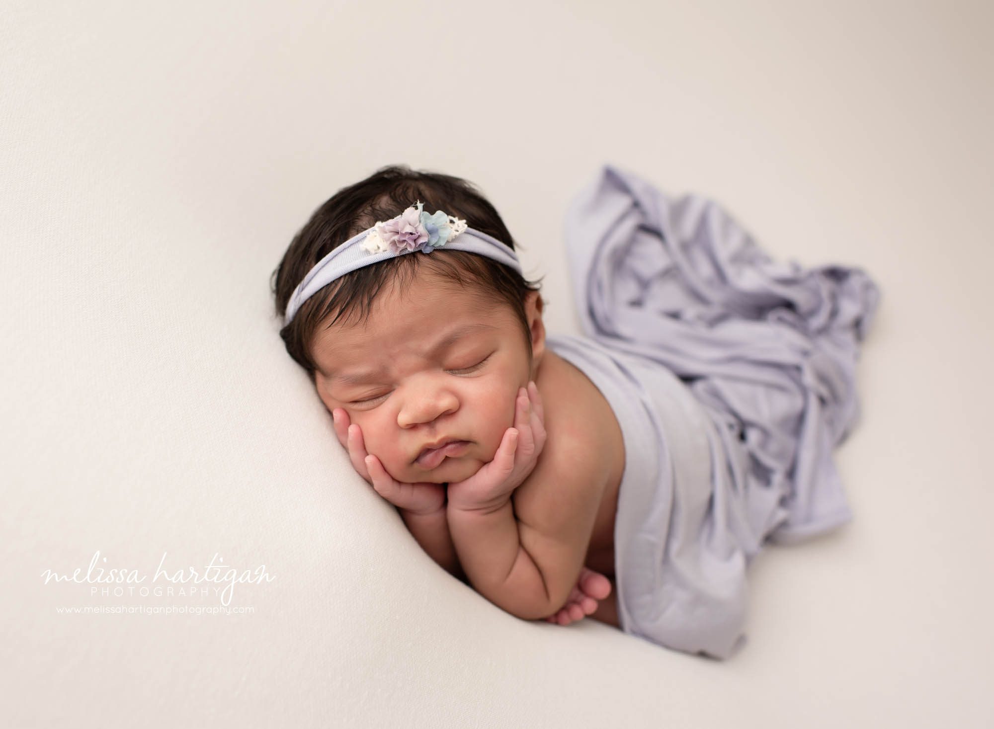 baby girl posed newborn photography pose with light purple wrap draped over her CT maternity newborn photographer