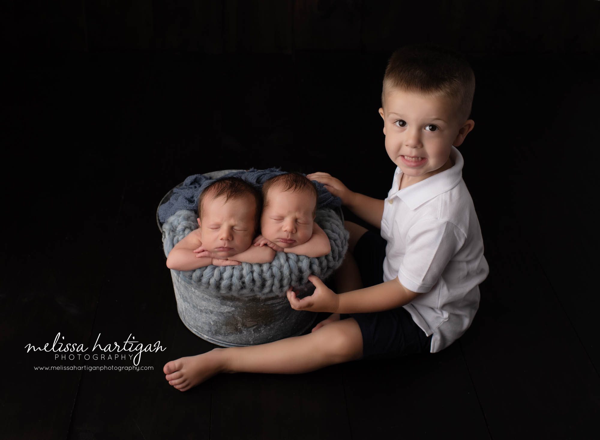 twin boys posed in metal bucket with big brother sitting side bucket family posestudio newborn photography pose South Windsor CT newborn Photographer