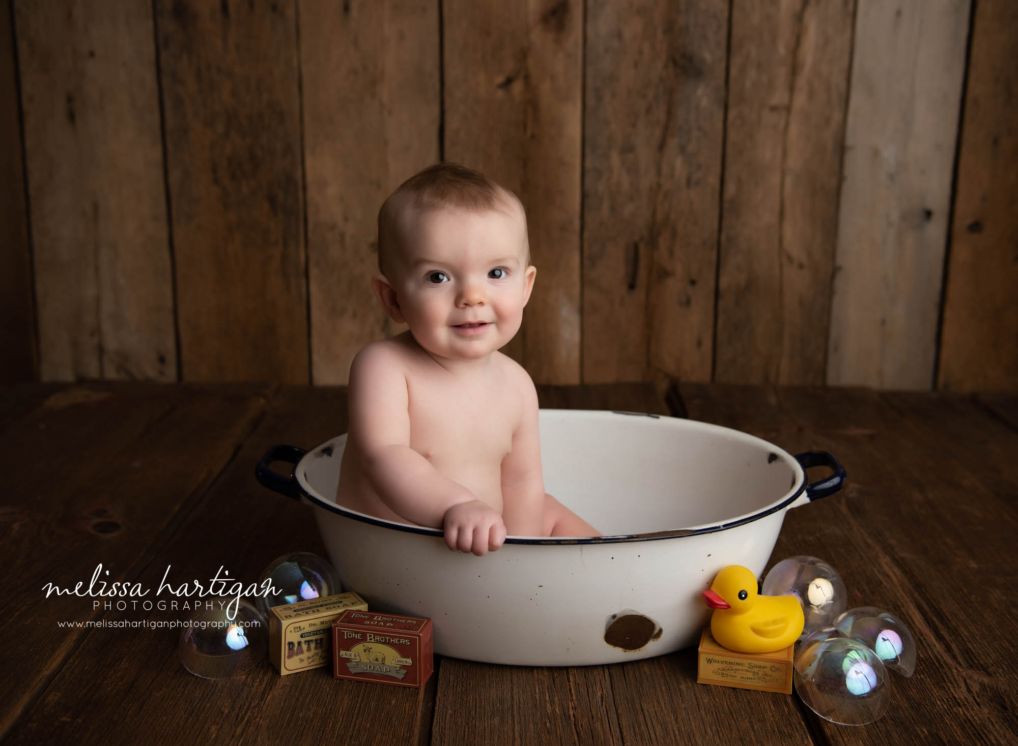 baby boy sitting in ceramic bath tub prop Andover CT baby photography session