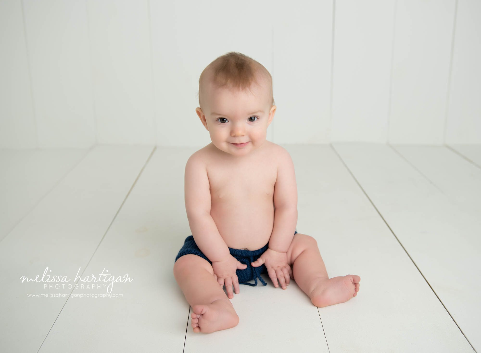 baby boy sitting cream wooden boards baby milestone photography connecticut