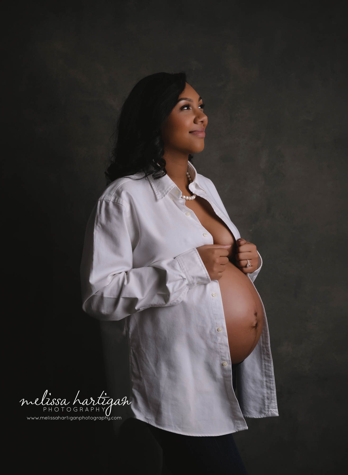 pregnant mom wearing dads dress shirt showing off bare baby bump studio maternity photography CT