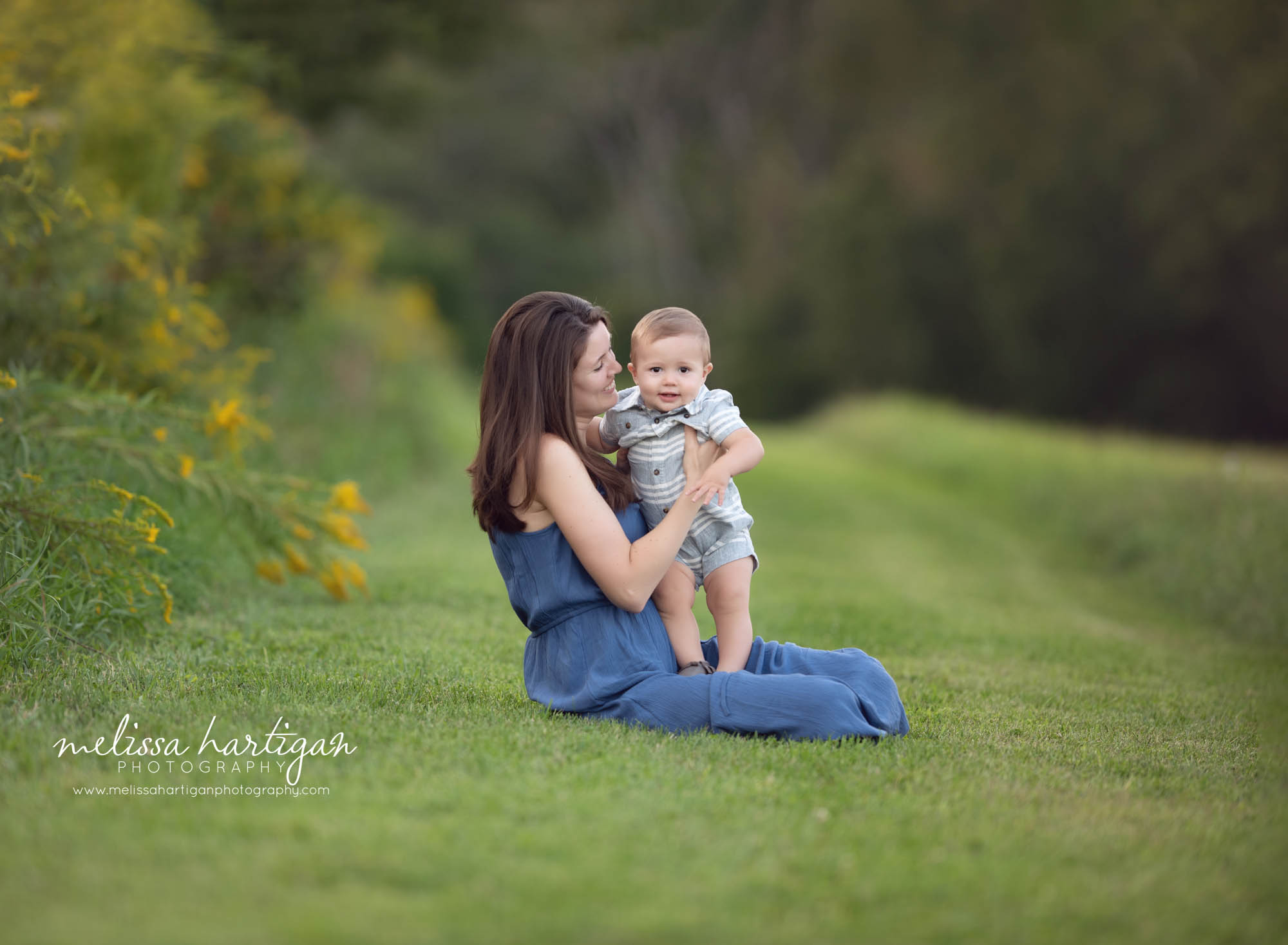 mom and toddler boy sitting in grass outside family photography CT