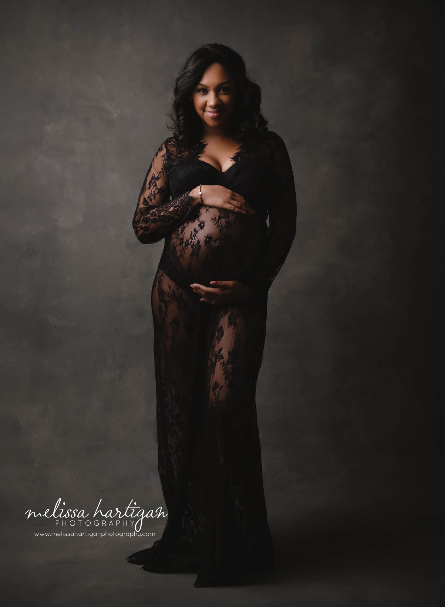 stunning pregnant mom holding baby bump smiling studio maternity session CT maternity Photography New Britain CT Maternity Photography