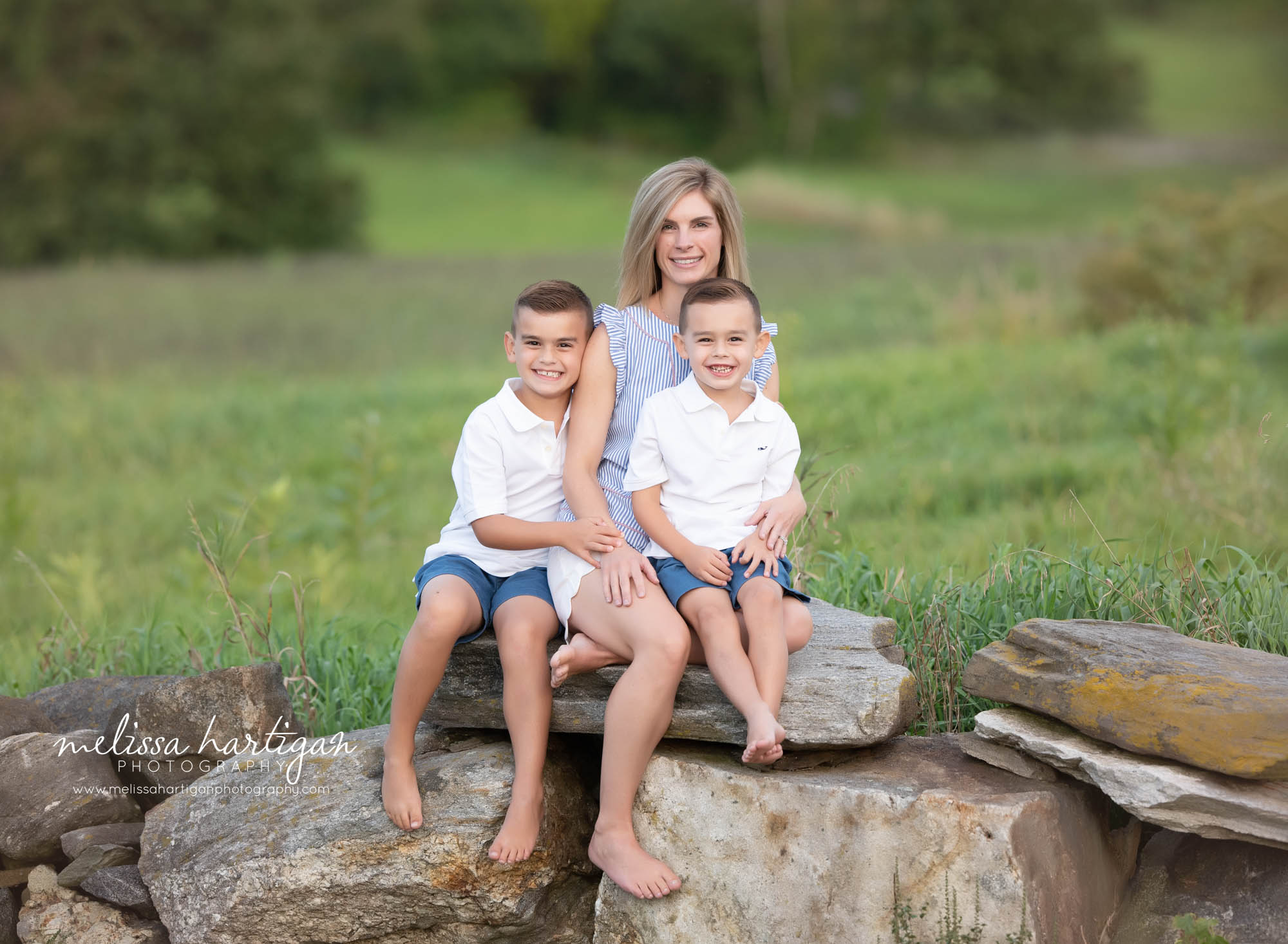 mom and two children sitting on rocks family photo CT family Photography