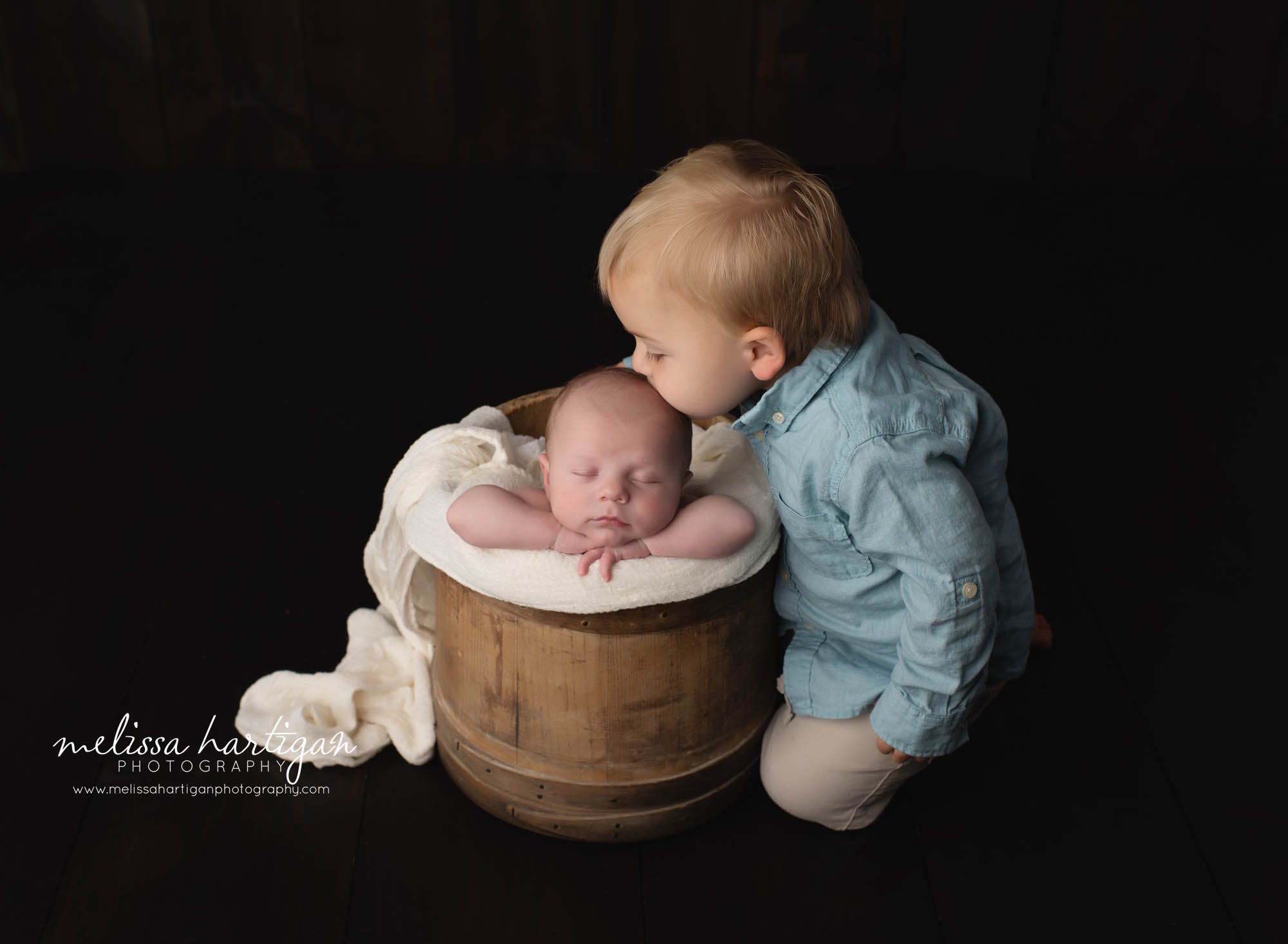 newborn and older sibling sitting next to bucket baby posed in CT Newborn Photographer