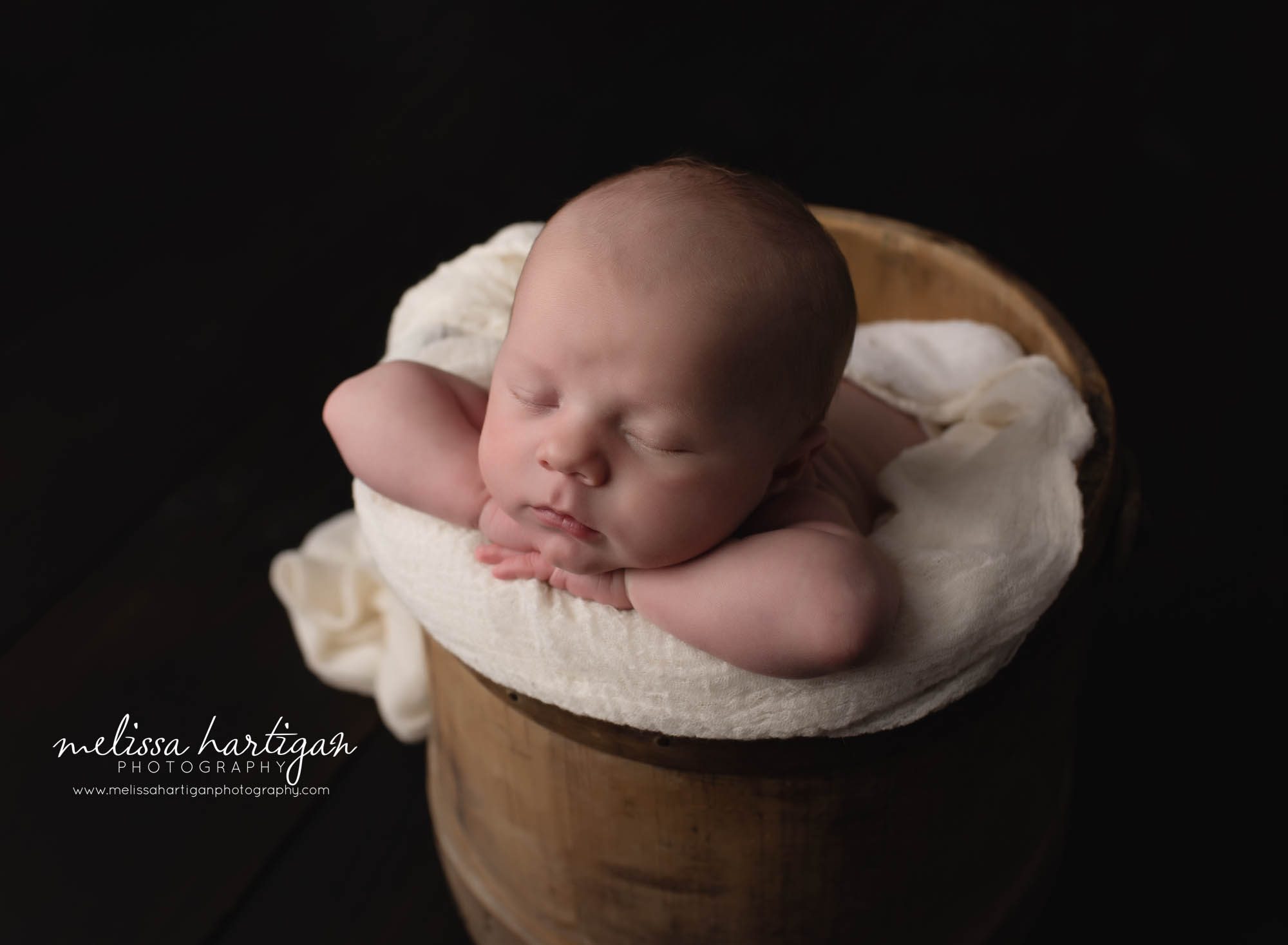 newborn baby boy posed in wooden bucket coventry CT newborn photographer