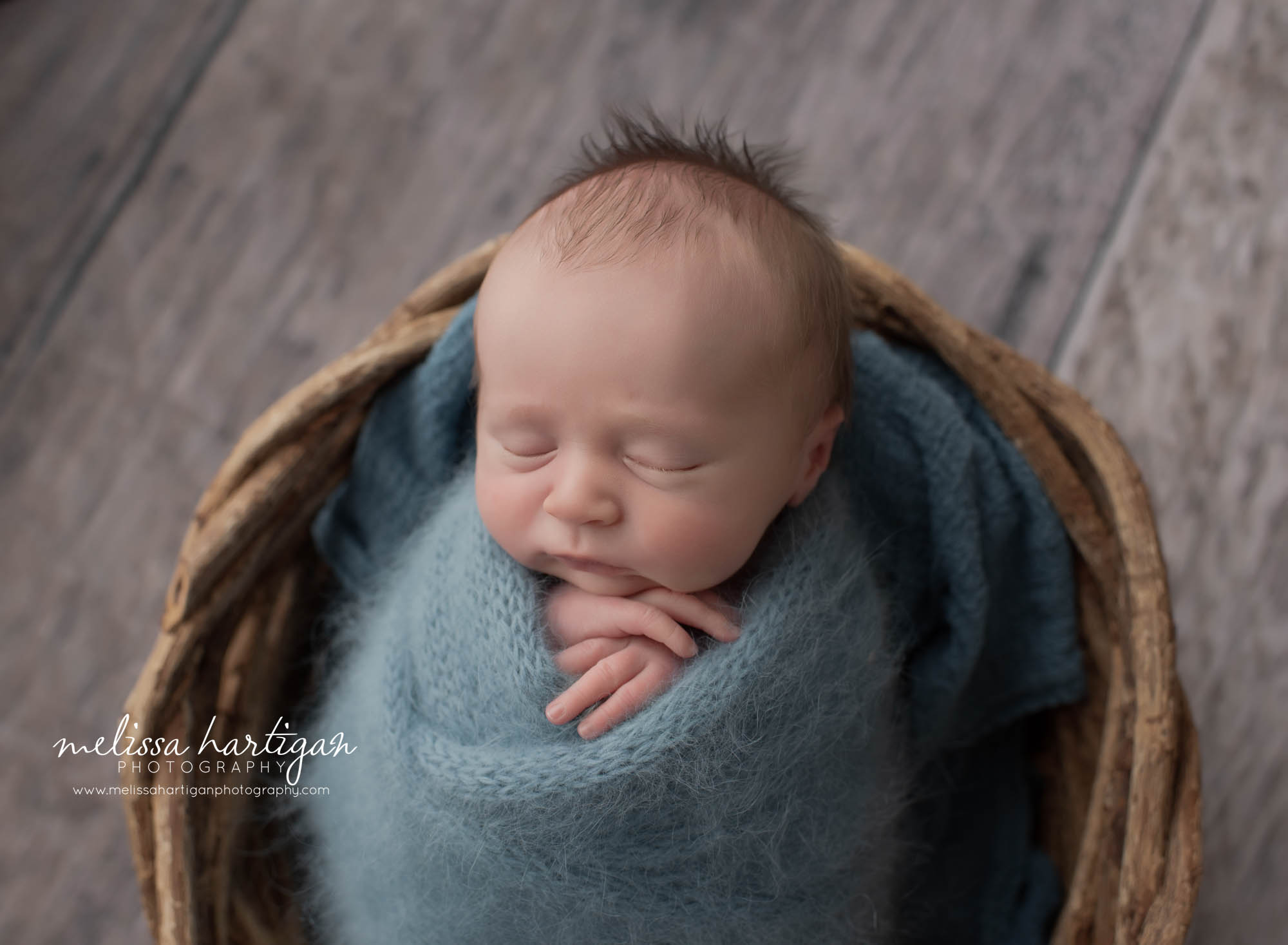 baby boy posed in basket blue knit wrap tater pose