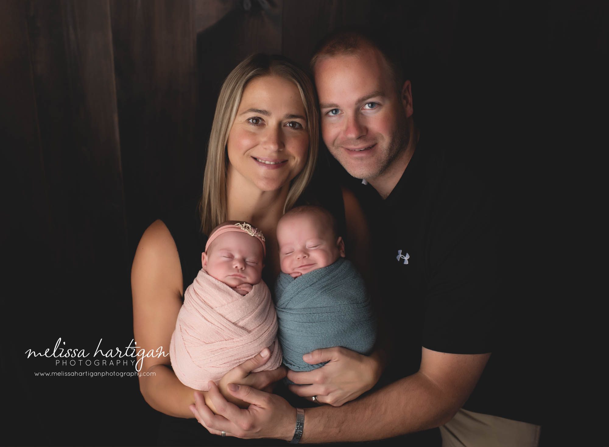 mom dad holding twin babies studio newborn family photography session