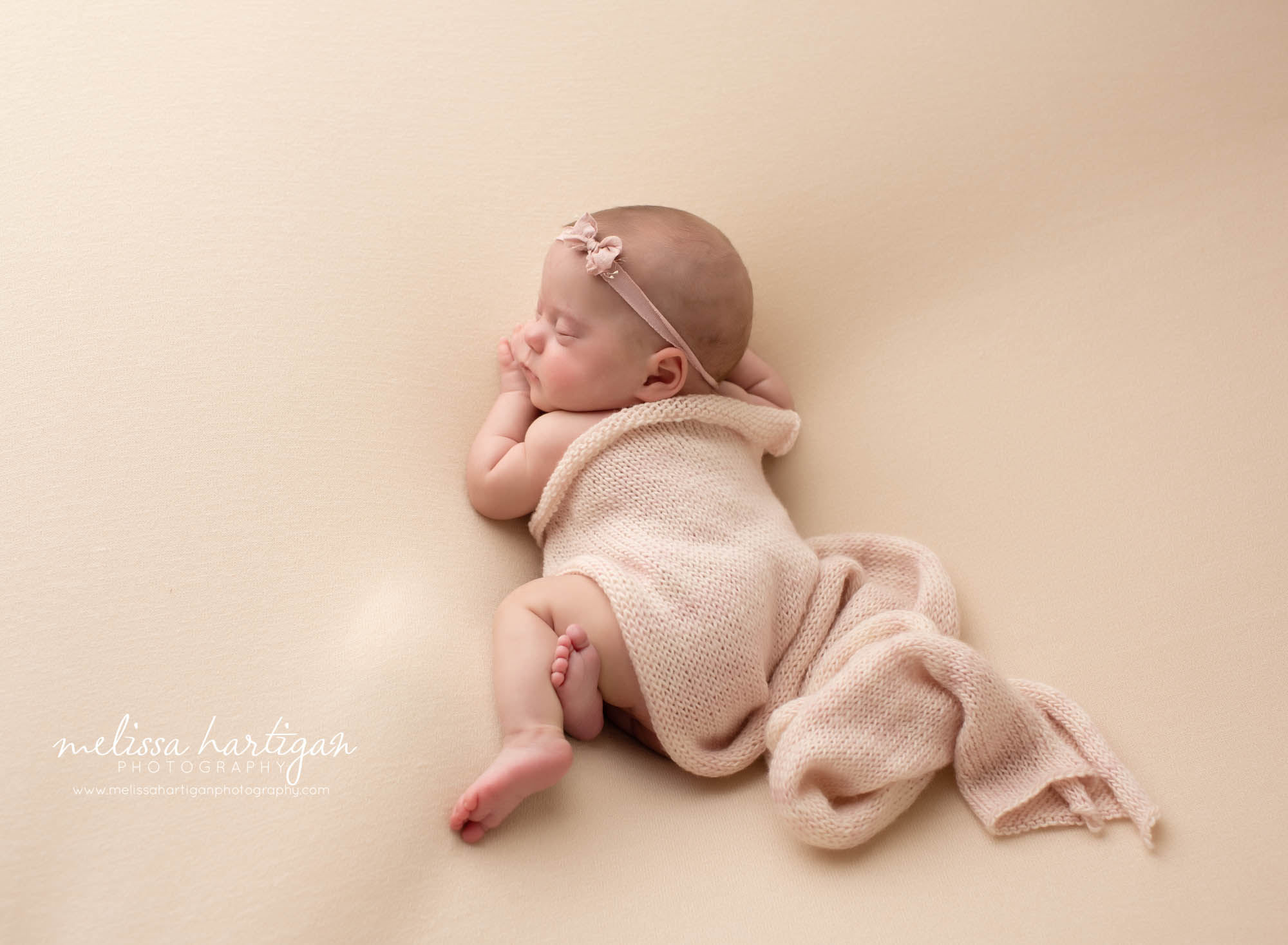 newborn girl posed on side with pink knitted layer wrap newborn photographer connecticut