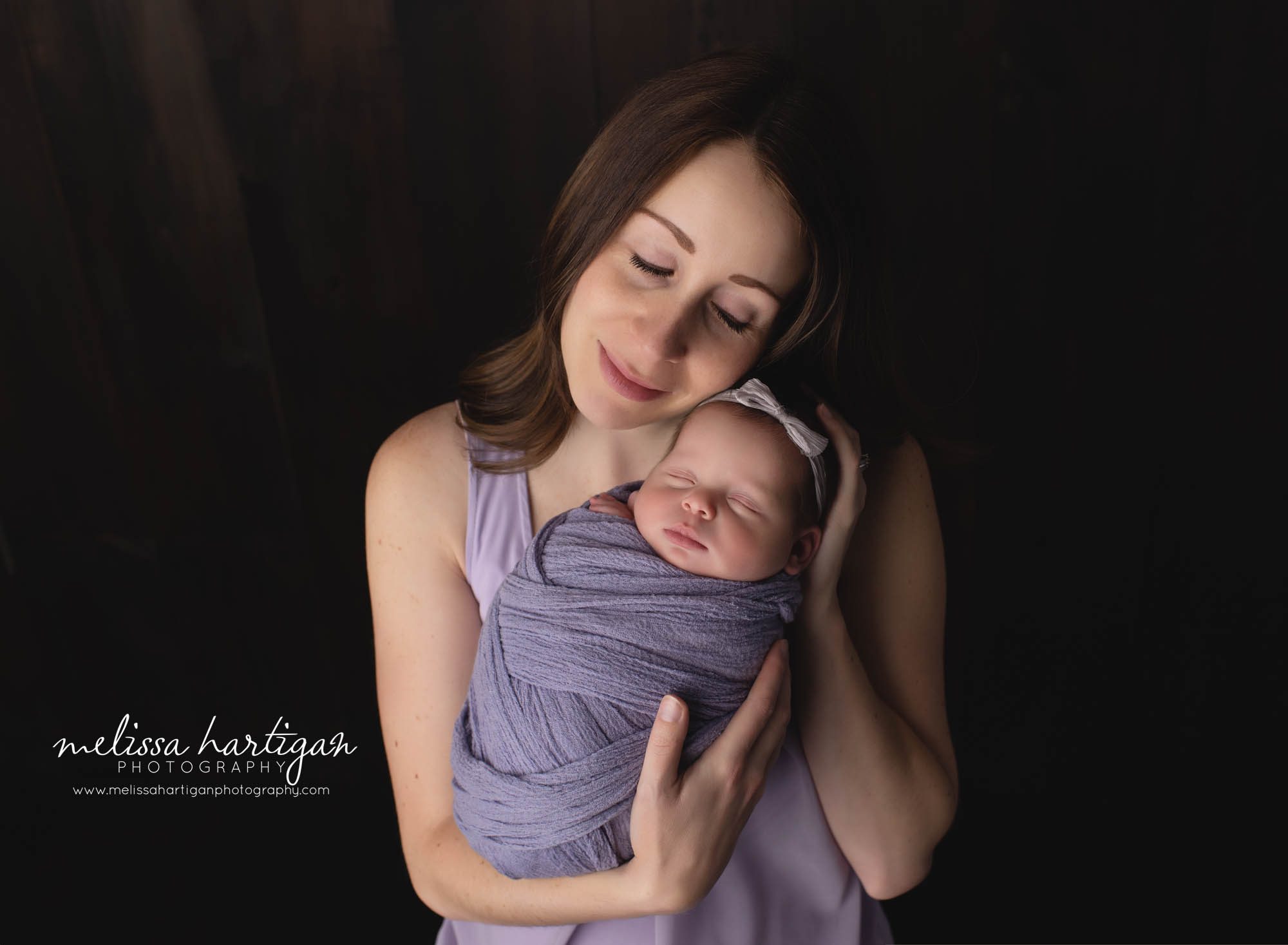 mom holding baby girl newborn family session