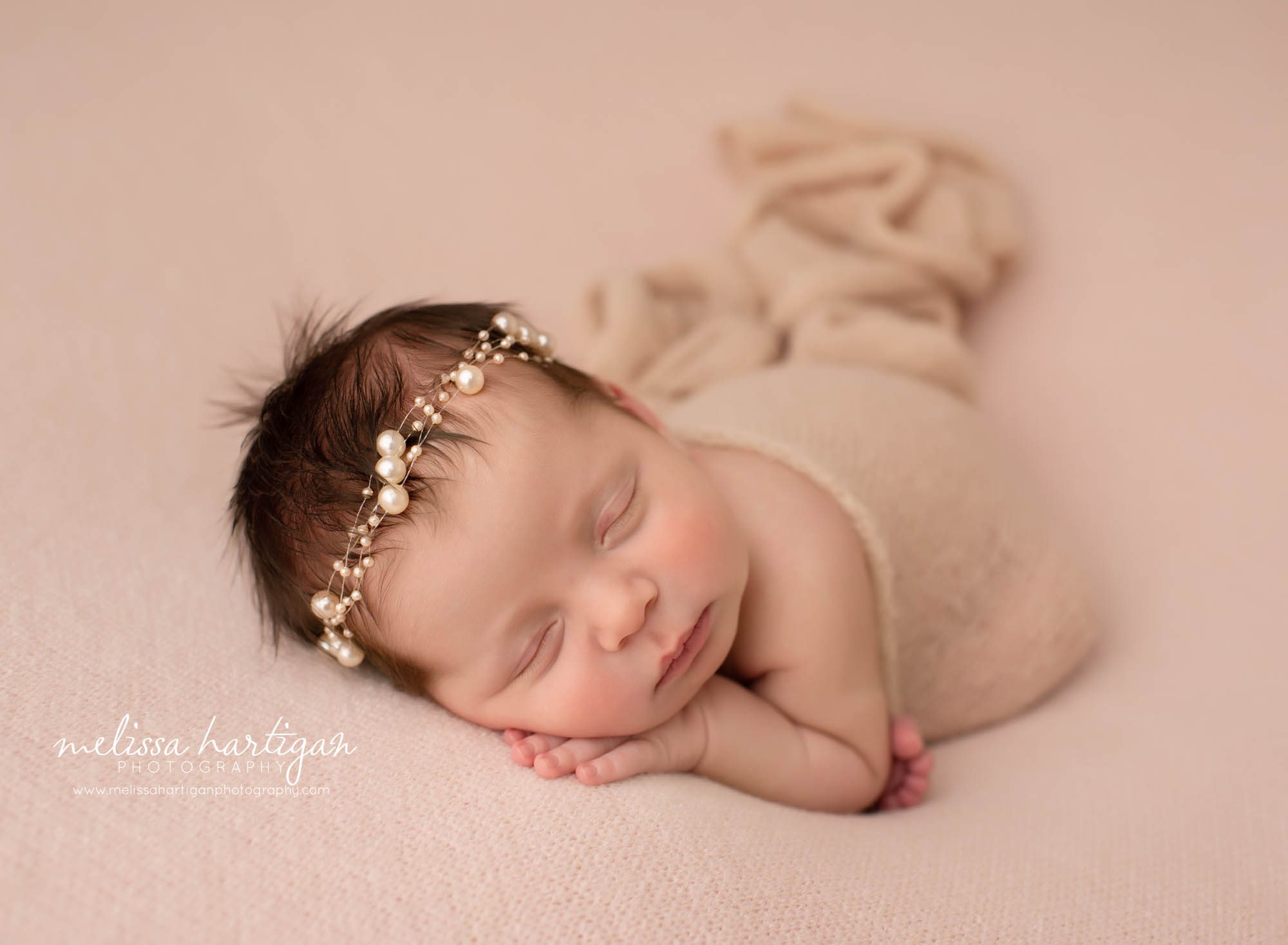 newborn baby girl posed on blush pink blanket with beaded headband Baby Photographer CT