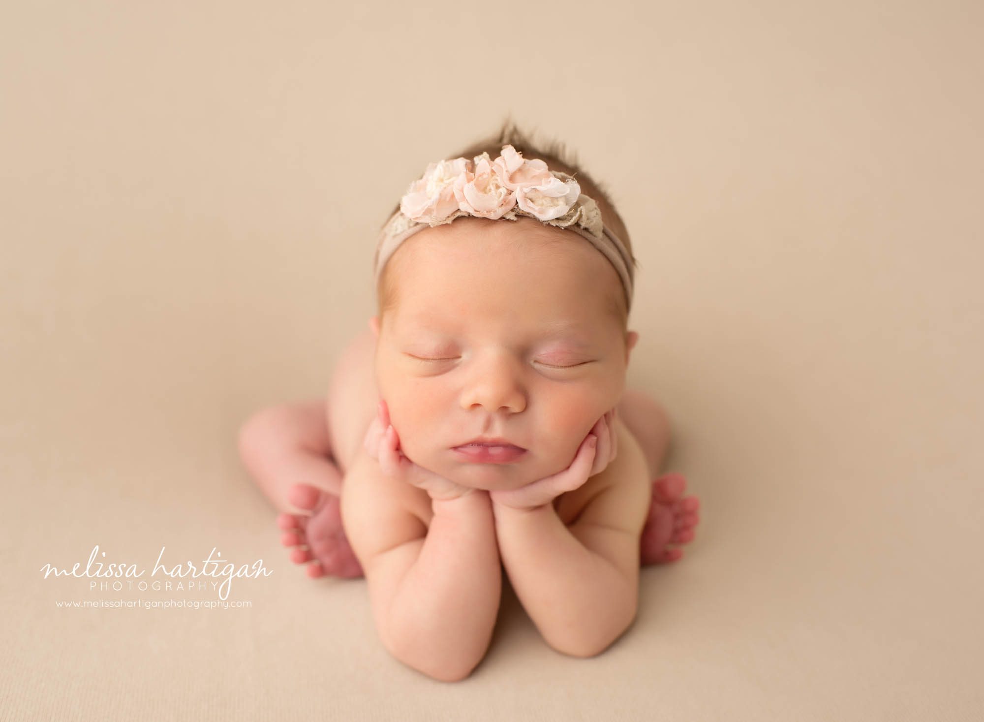 newborn baby girl posed froggy pose flower headband