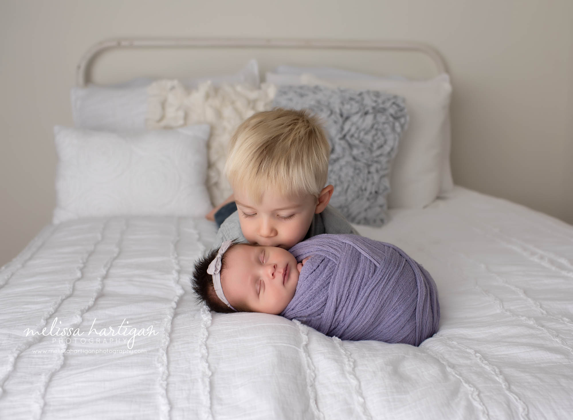 big brother and wrapped newborn baby girl sibling photos