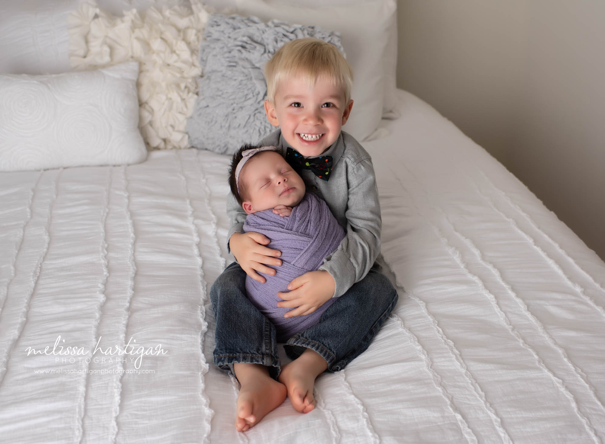 big brother holding wrapped baby sister sibling photos