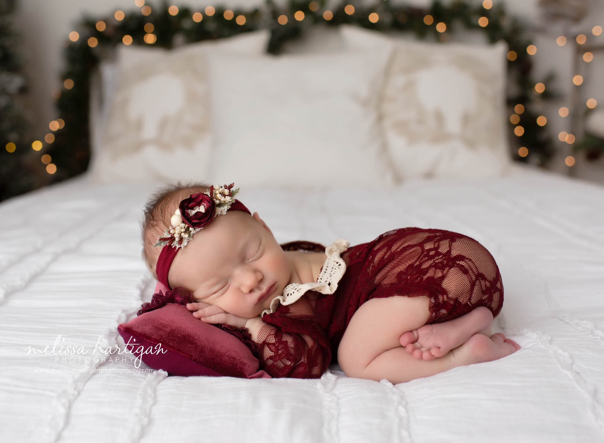 Nebworn baby girl posed on tummy christmas holiday photo set up newborn photography connecticut